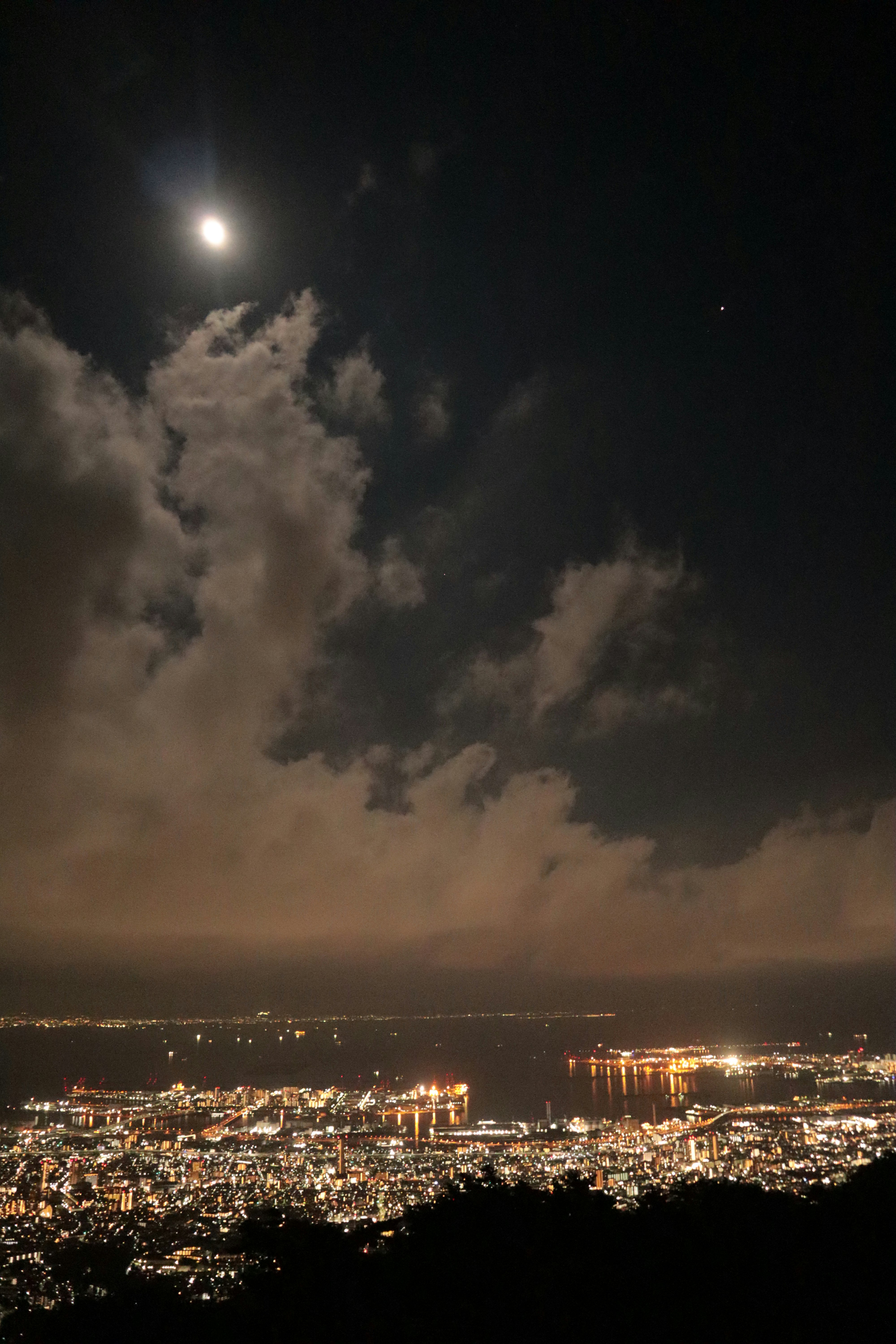 night sky clouds over a city skyline