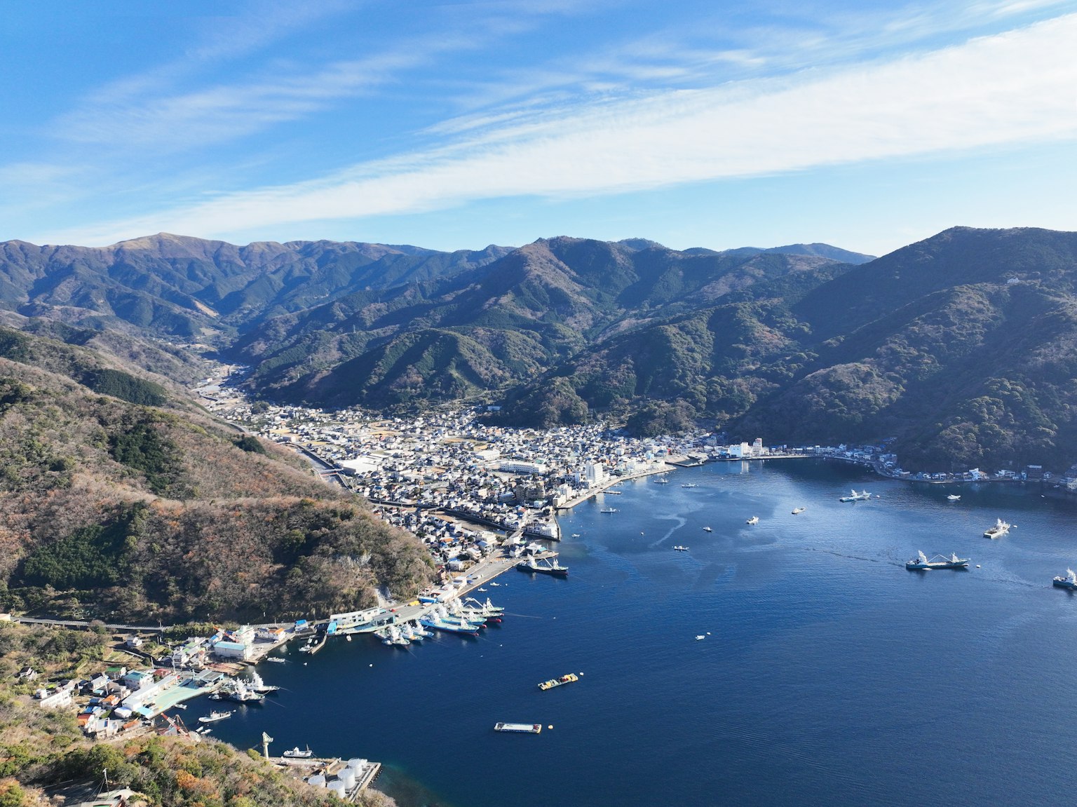Aerial view of a coastal town surrounded by mountains