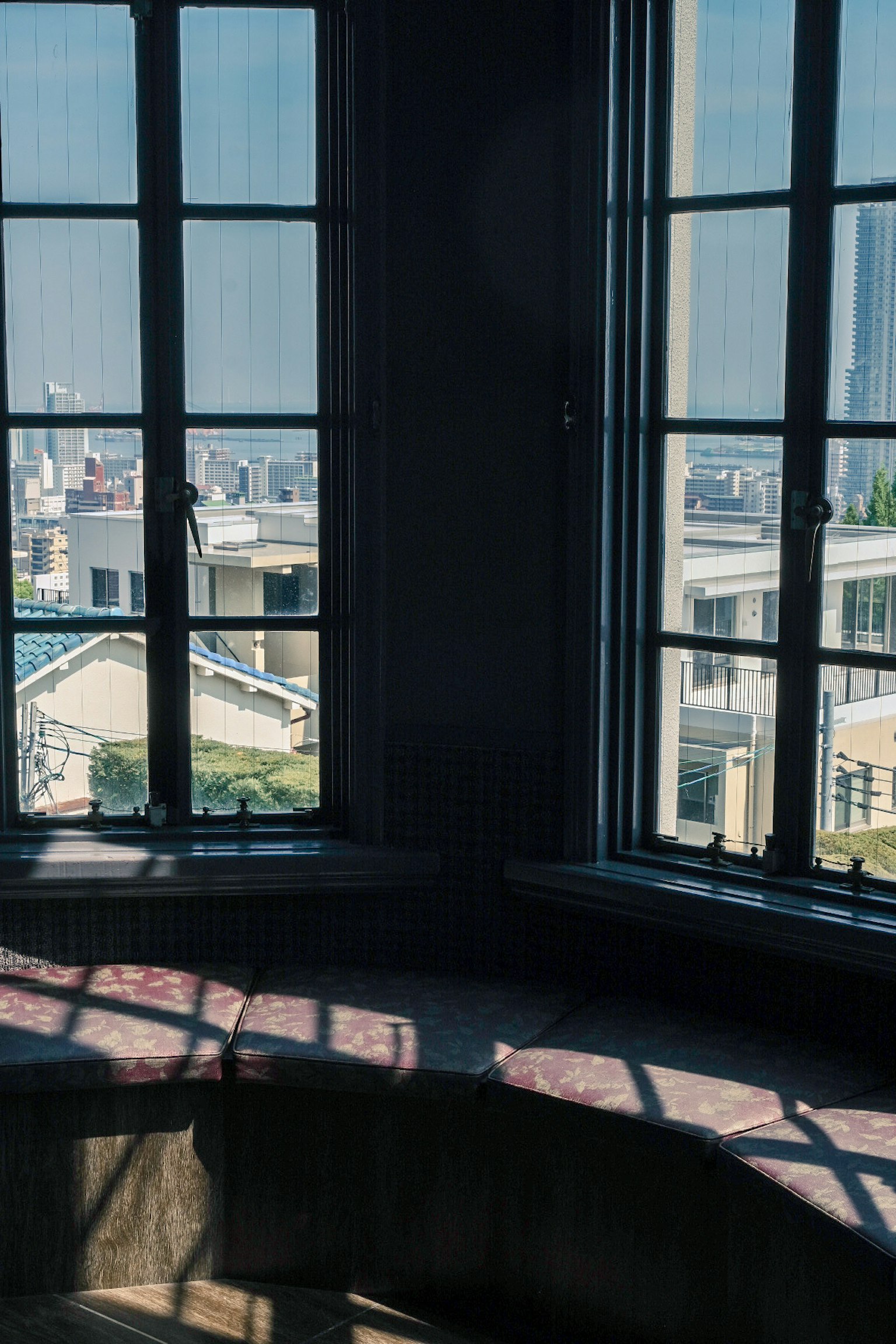 View from windows, rooftops of buildings, shadows on interior