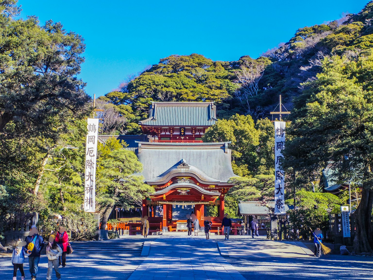 Beautiful shrine entrance surrounded by green trees and blue sky