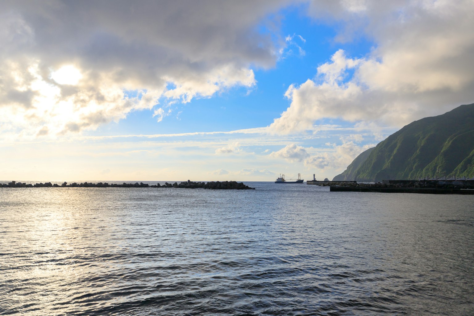 Calm sea landscape under a blue sky with clouds