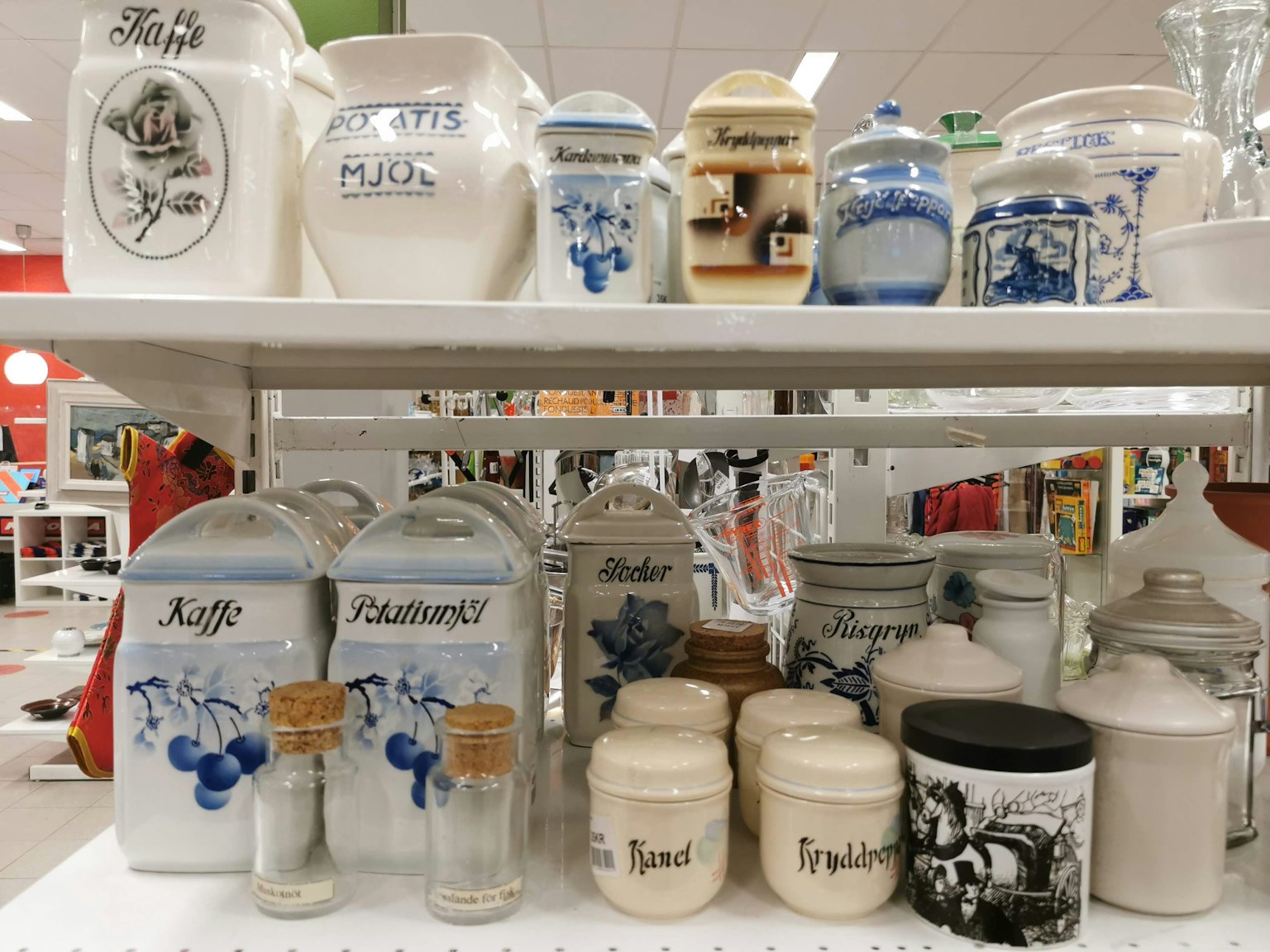 A display of colorful ceramic jars arranged on a shelf