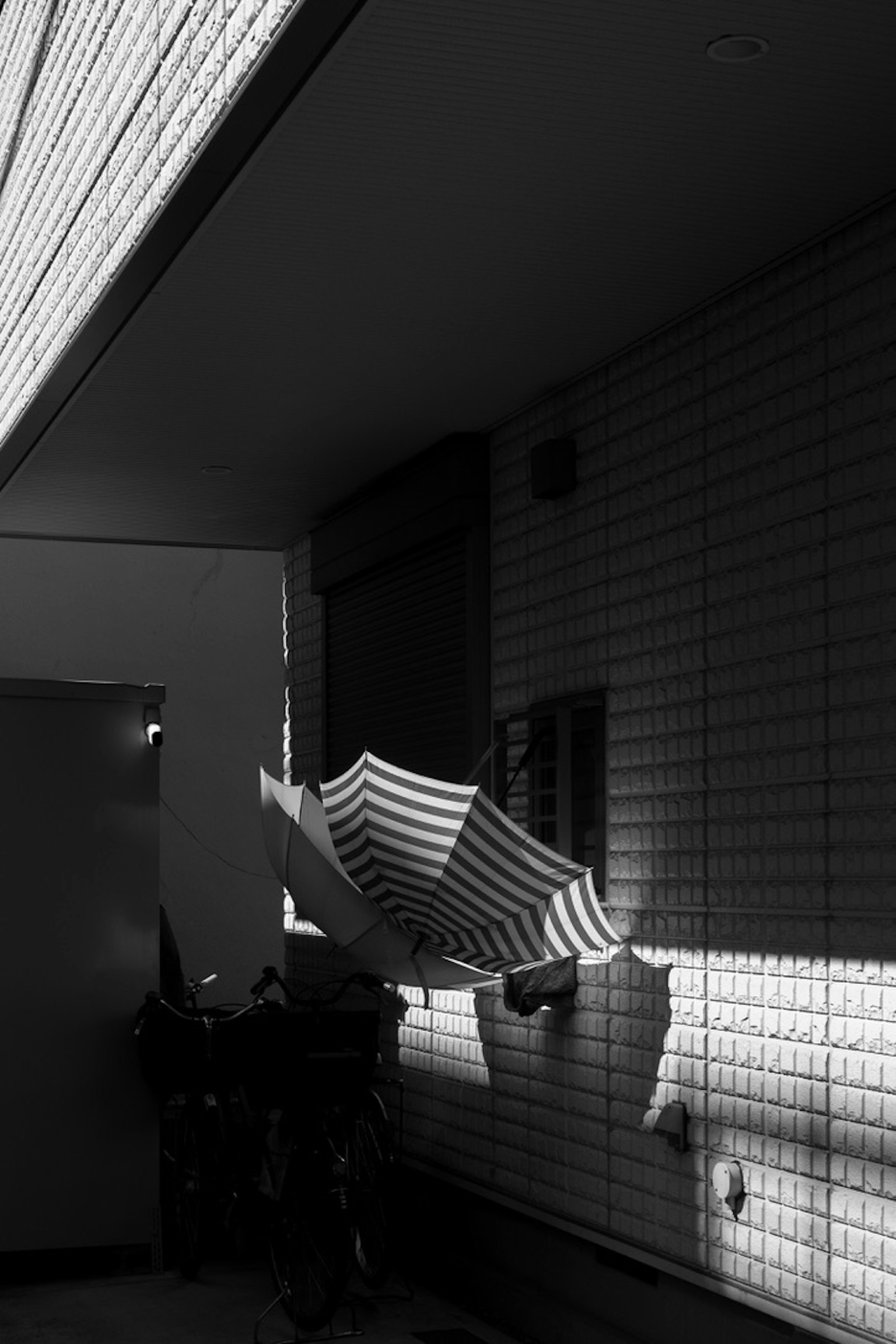 Black and white interior scene with shadows Laundry hanging on a line