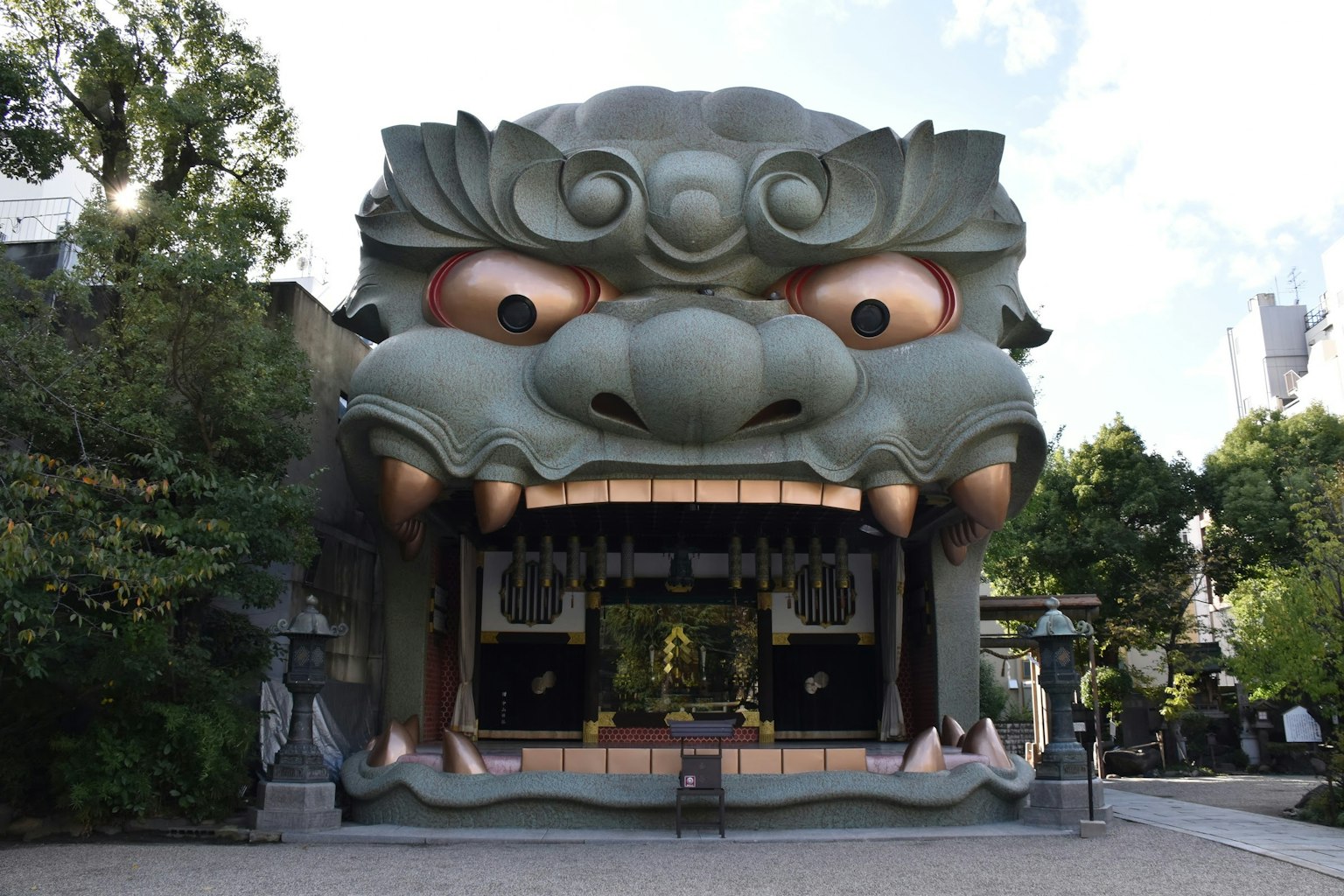 Building featuring a giant lion face with a shrine visible in its mouth