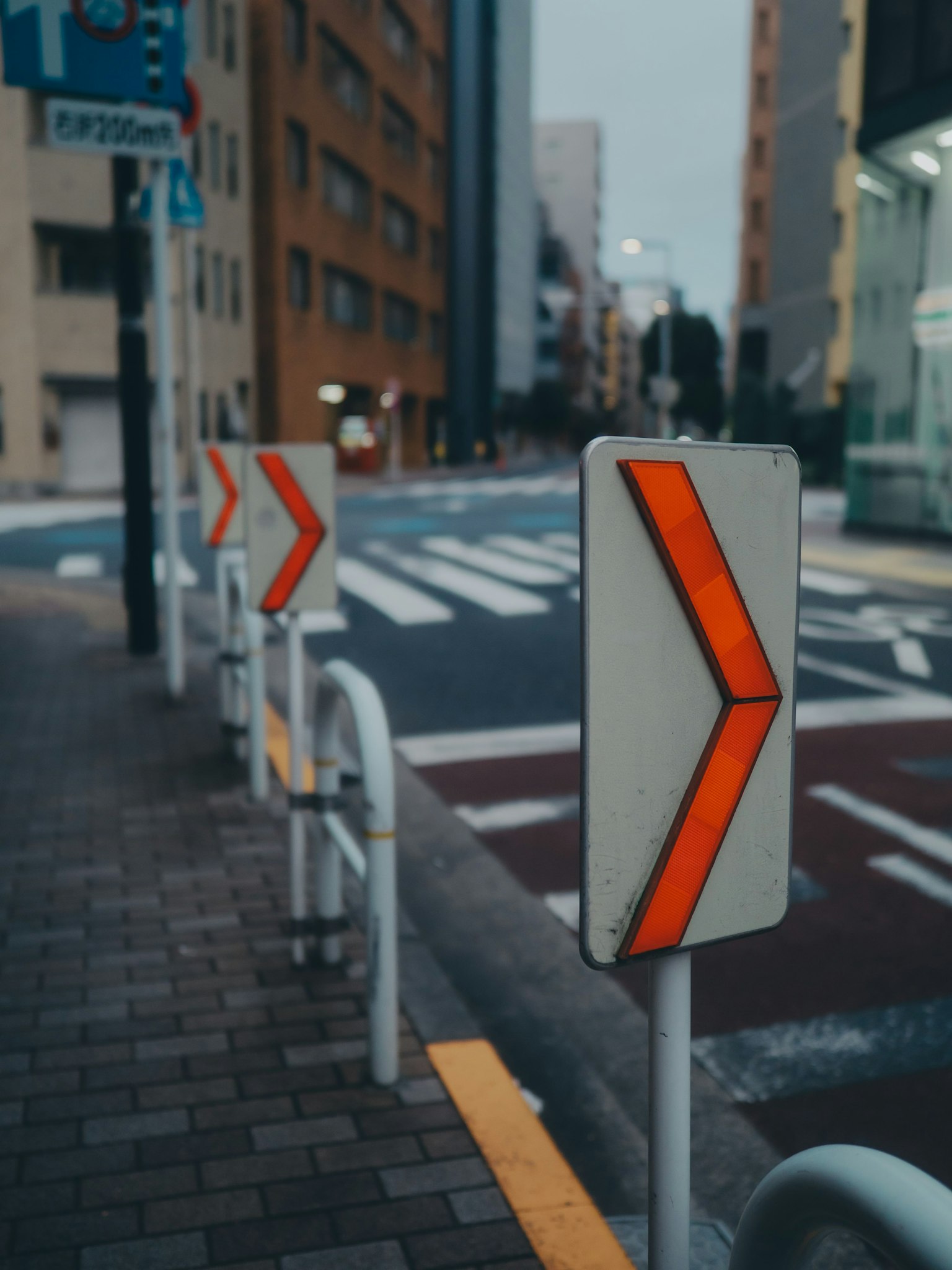 A view of traffic signs indicating right turns at an urban intersection