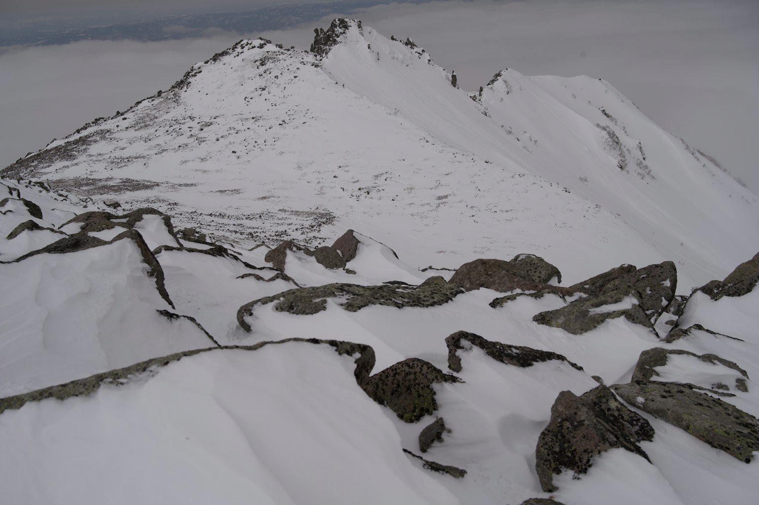 Snow-covered mountain landscape with rocky terrain