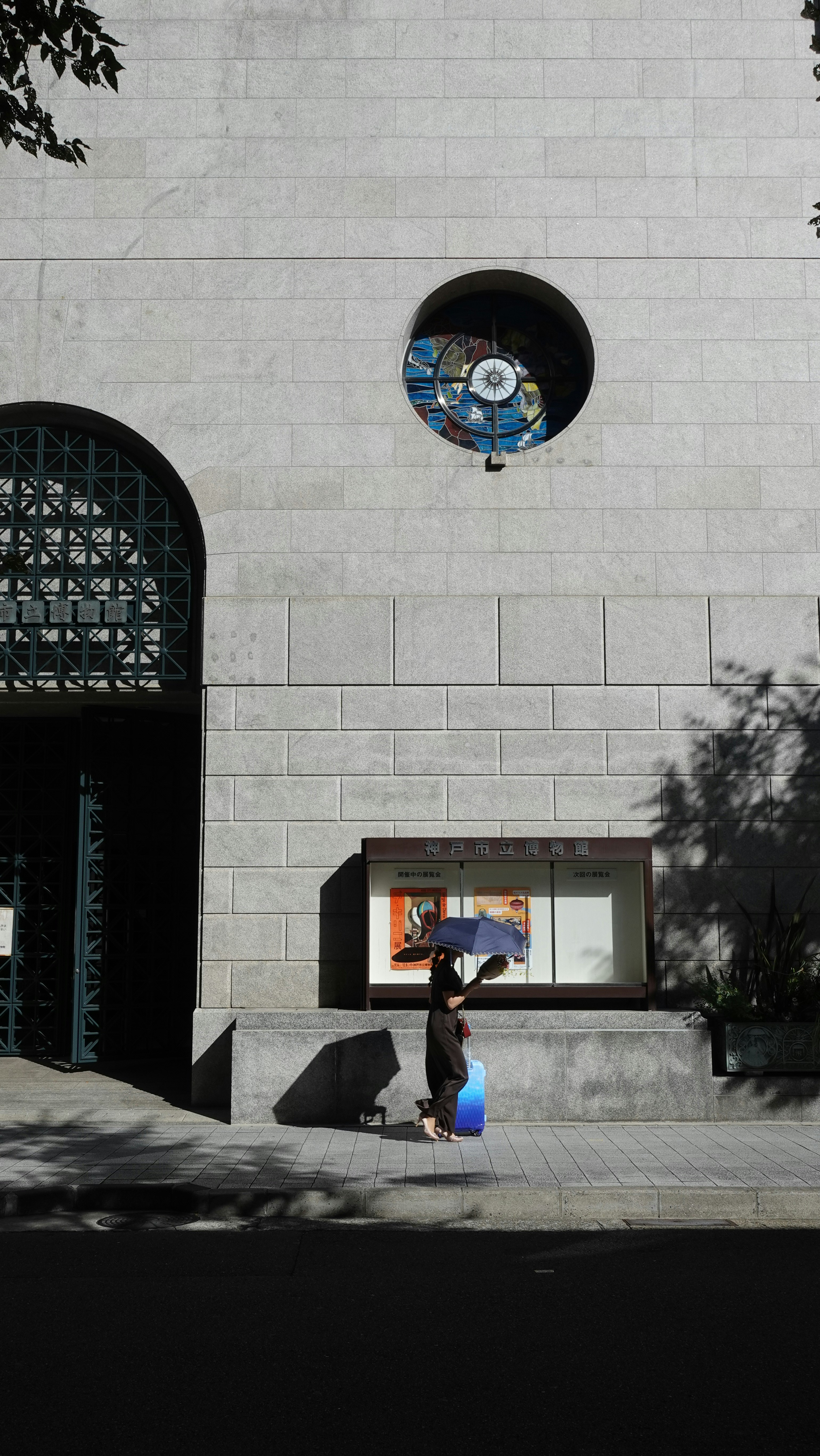 child filling a water container in a white courtyard