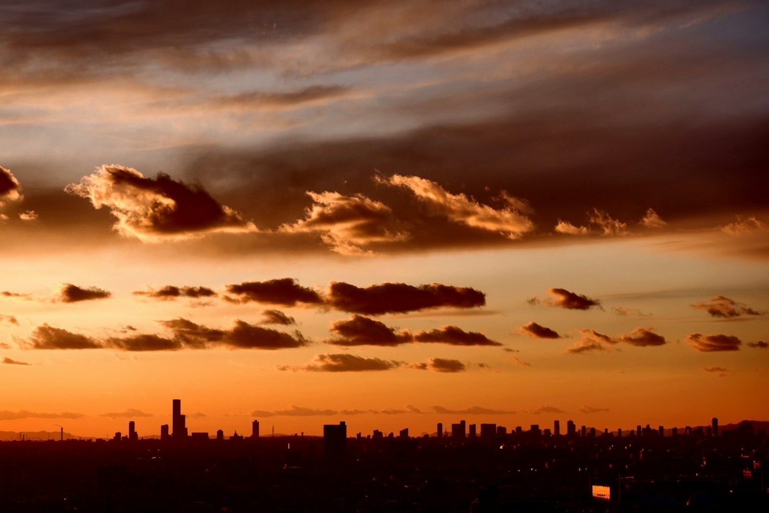 Silhouette de la ville au coucher du soleil avec des nuages