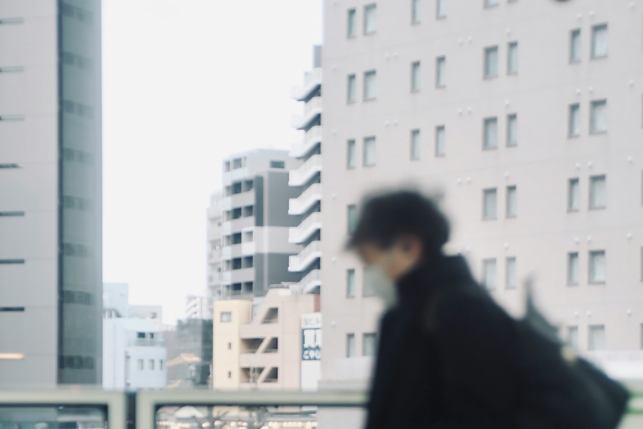 back view of a person walking in a city business district