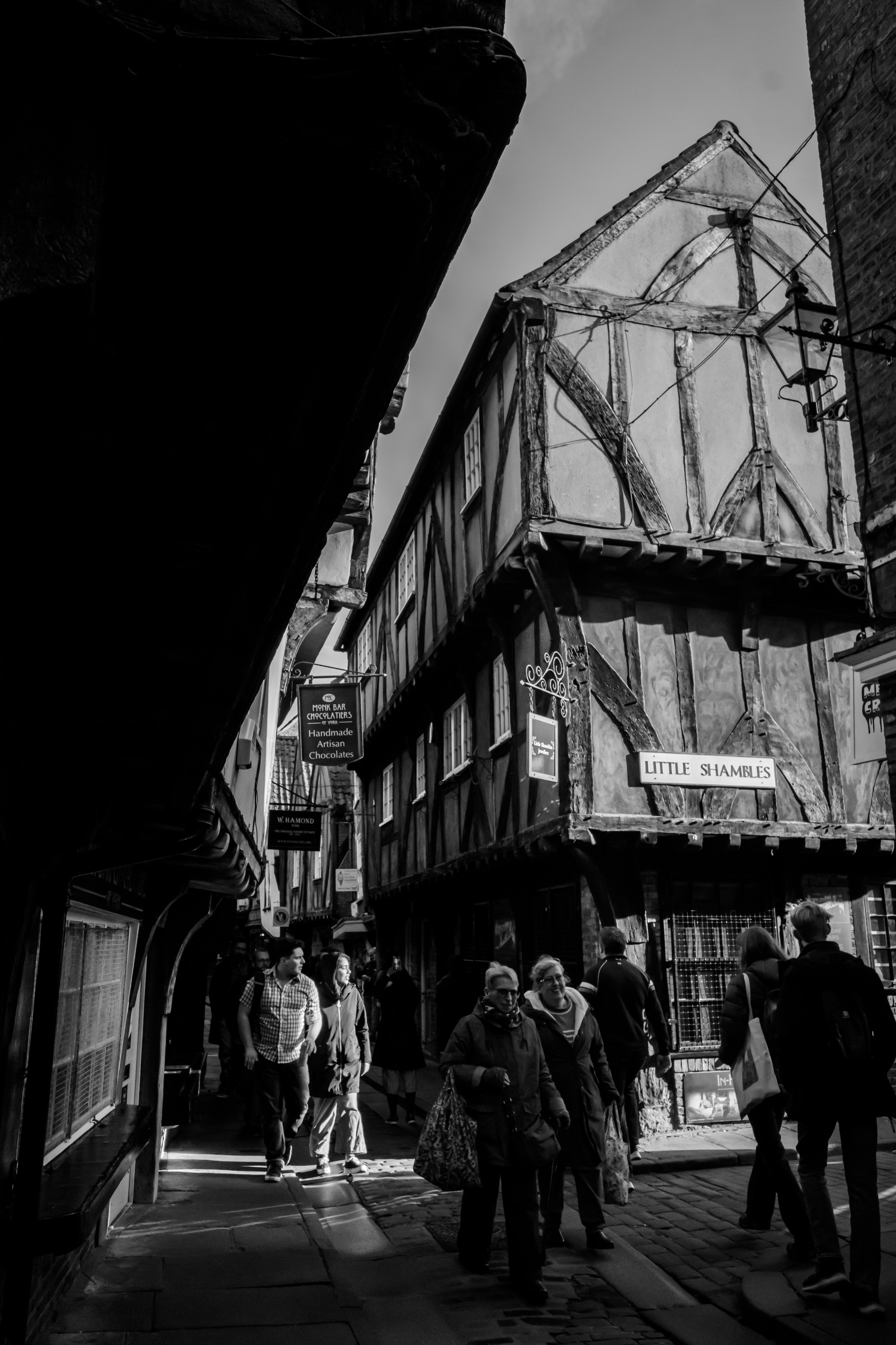 street alley with historic buildings and pedestrians in York, England
