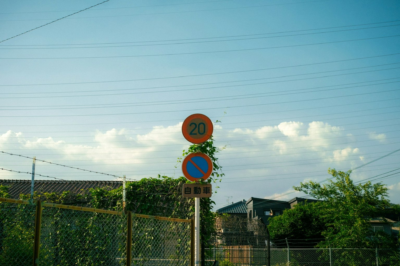Deux panneaux de signalisation sous un ciel bleu avec de la verdure autour
