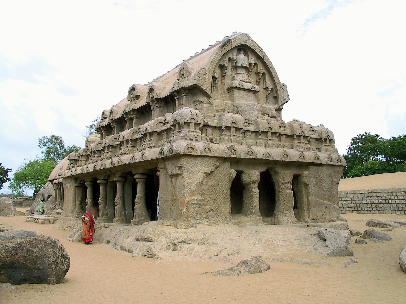 Ancient rock-cut temple structure of the Pancha Rathas in a sandy landscape