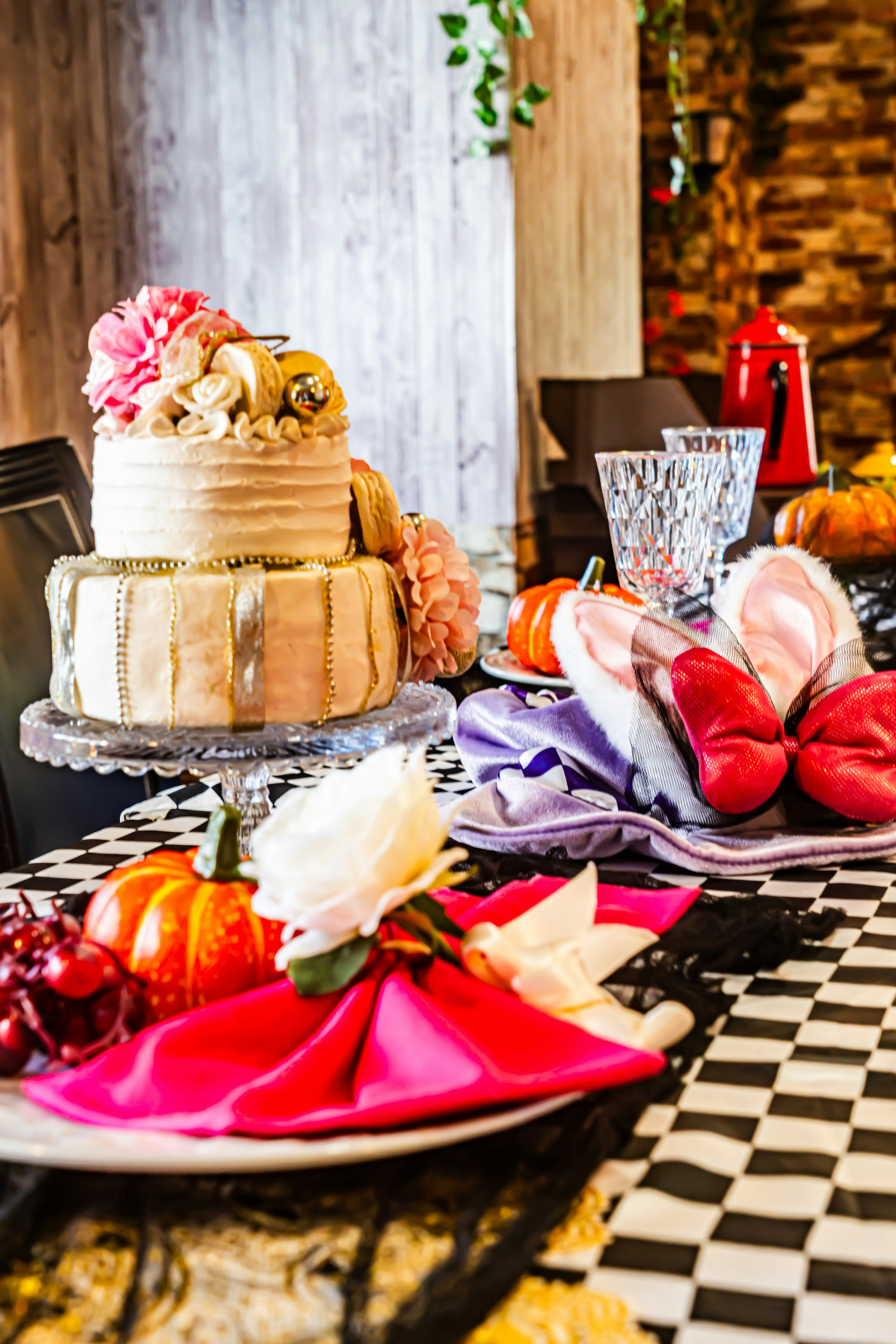 Wedding cake with ribbon and floral decorations on a dressed table