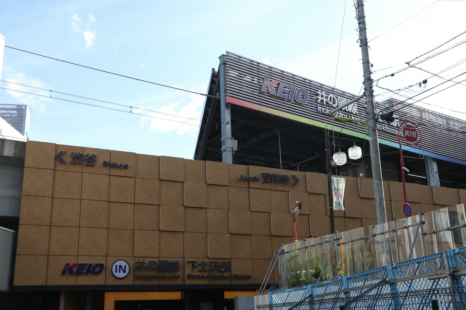 Exterior view of a building featuring Keio logos and colorful signage