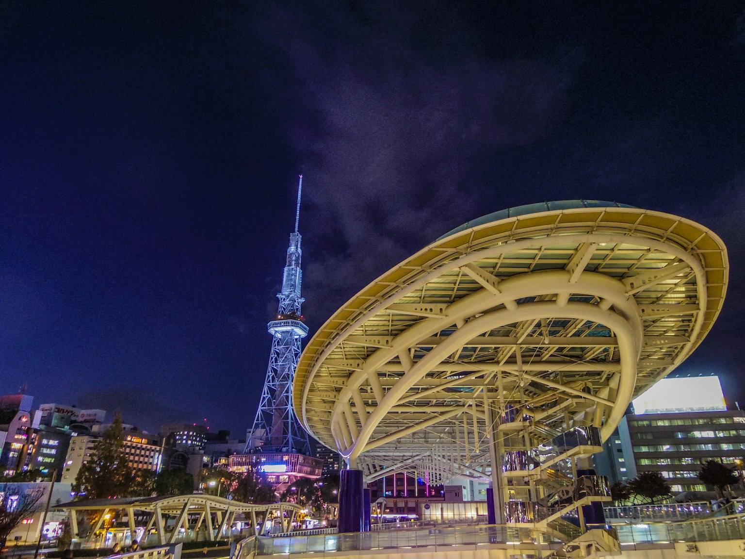 Nagoya TV Tower with futuristic roof structure illuminated against night sky