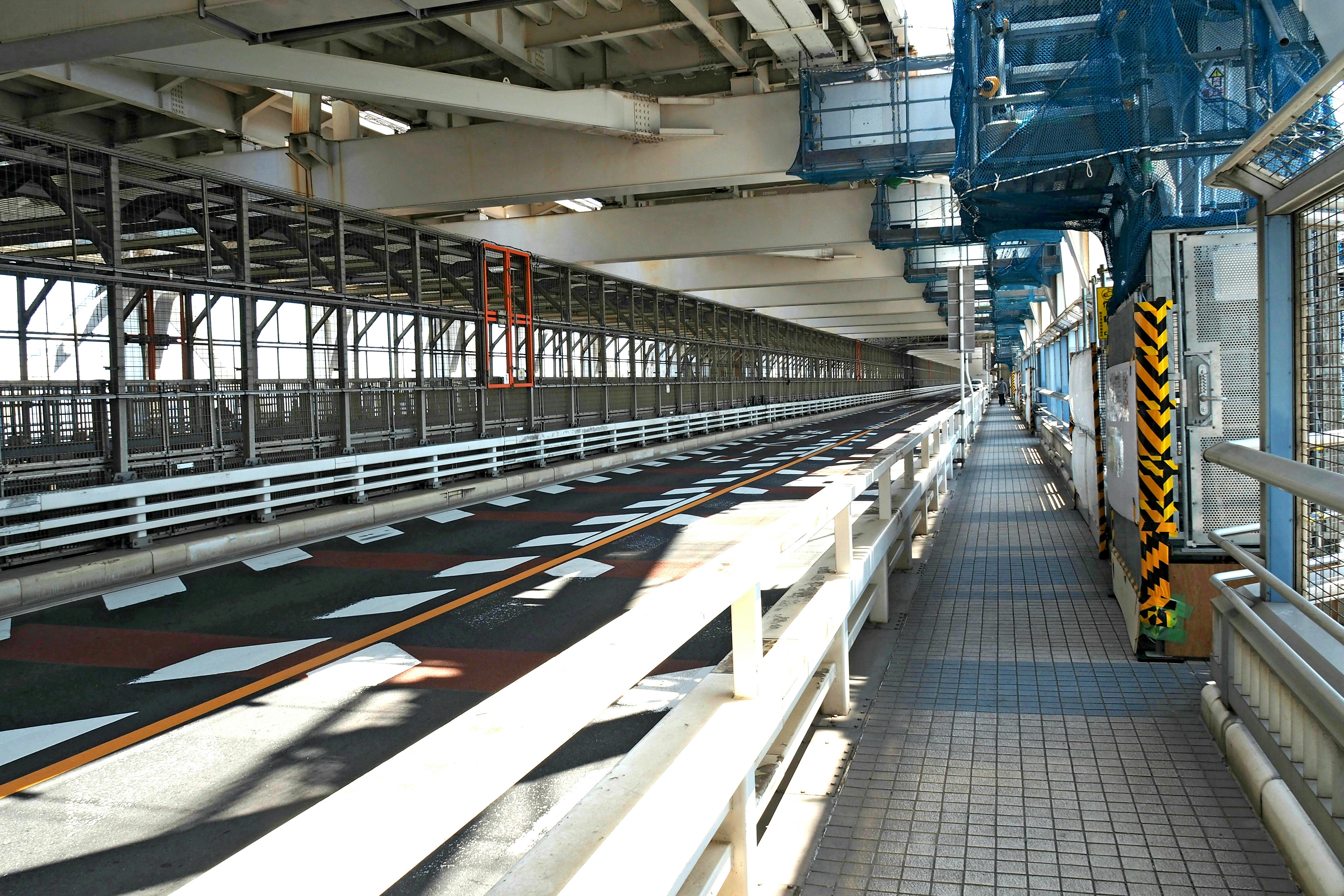 long factory corridor with belt conveyors and machinery
