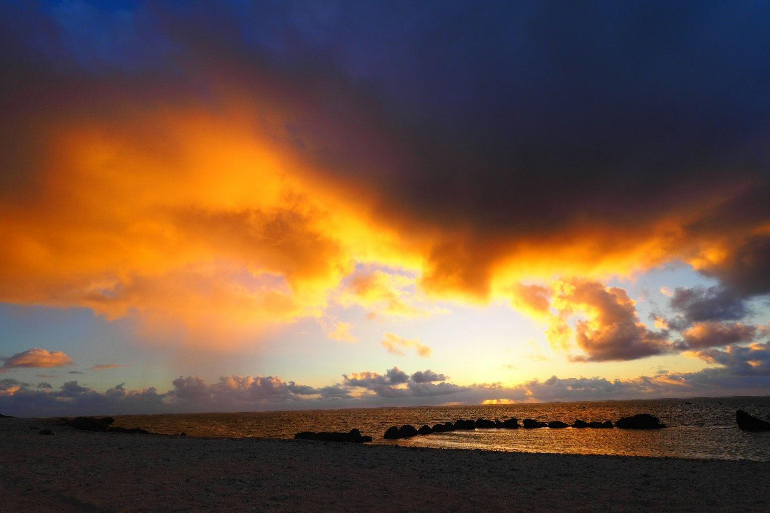 Stunning sunset beach scene with orange and blue clouds