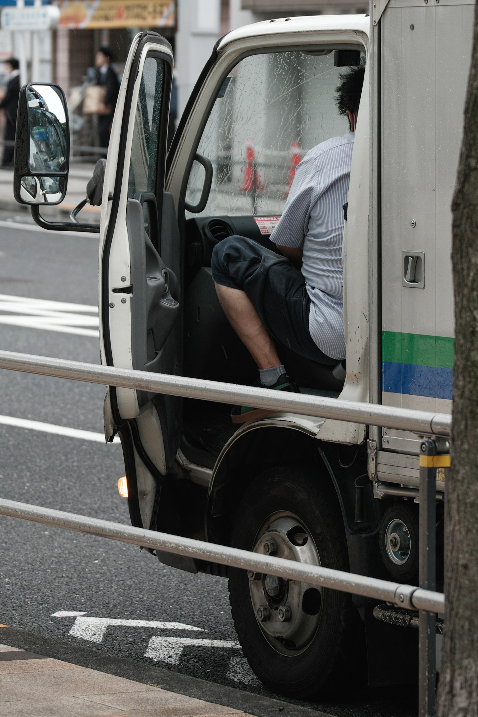 A man sitting in the driver's seat of a truck