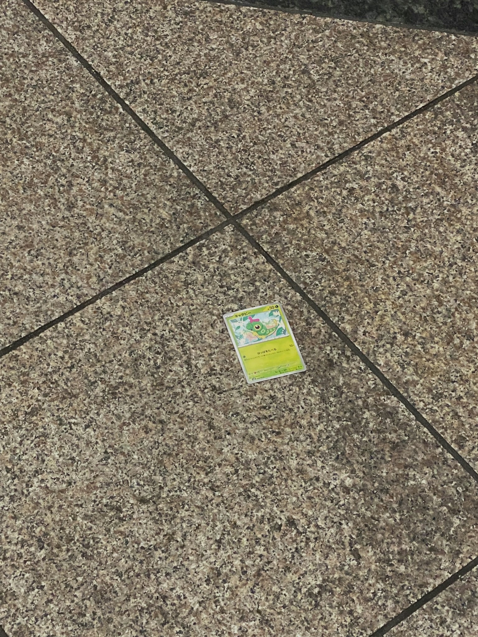 A bright yellow card on a paved surface