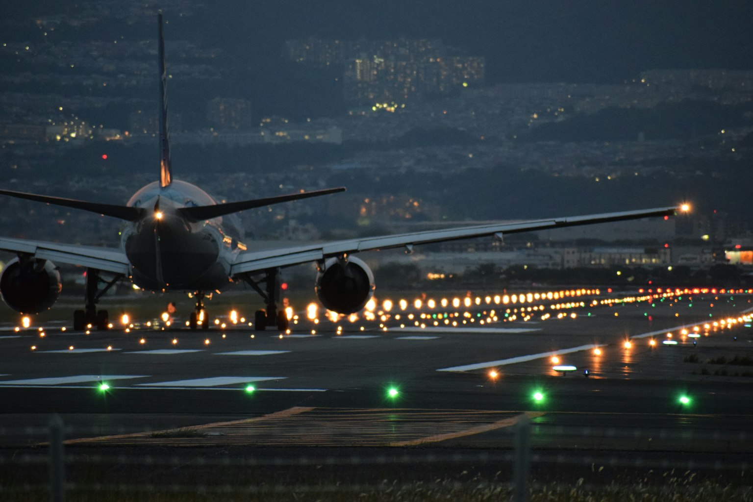 Airplane on the runway at night with illuminated lights