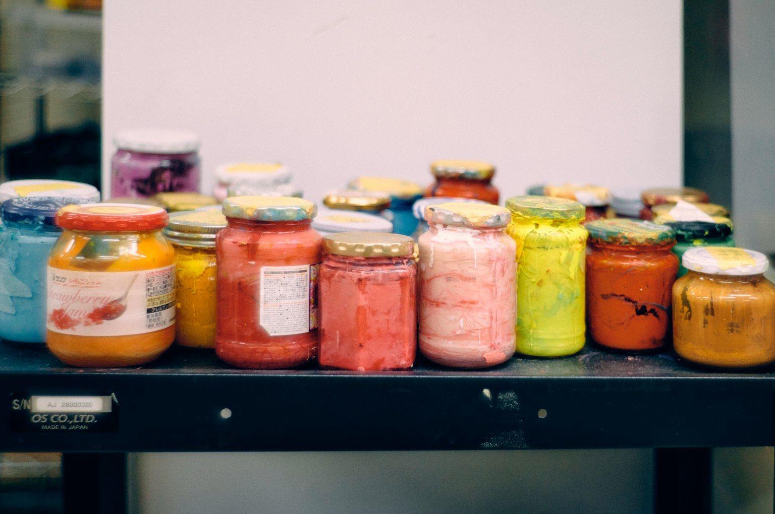 Colorful jars arranged on a shelf