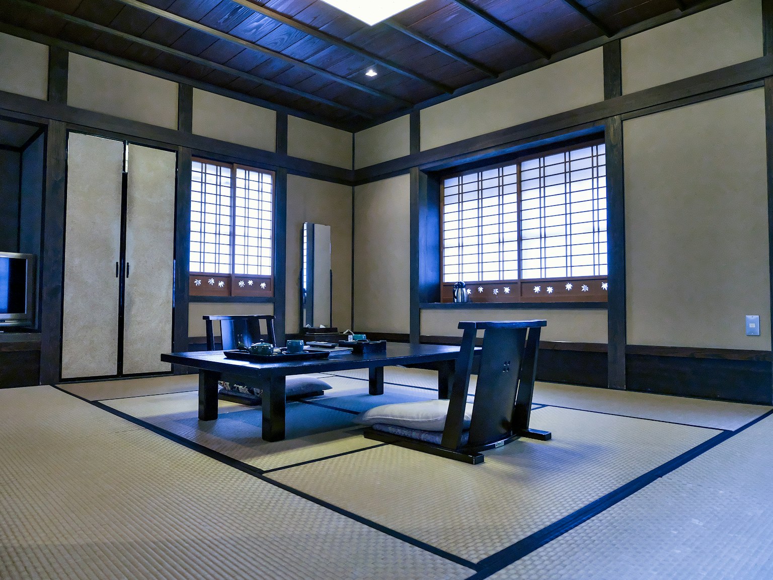 Traditional Japanese room with tatami flooring low table and shoji windows