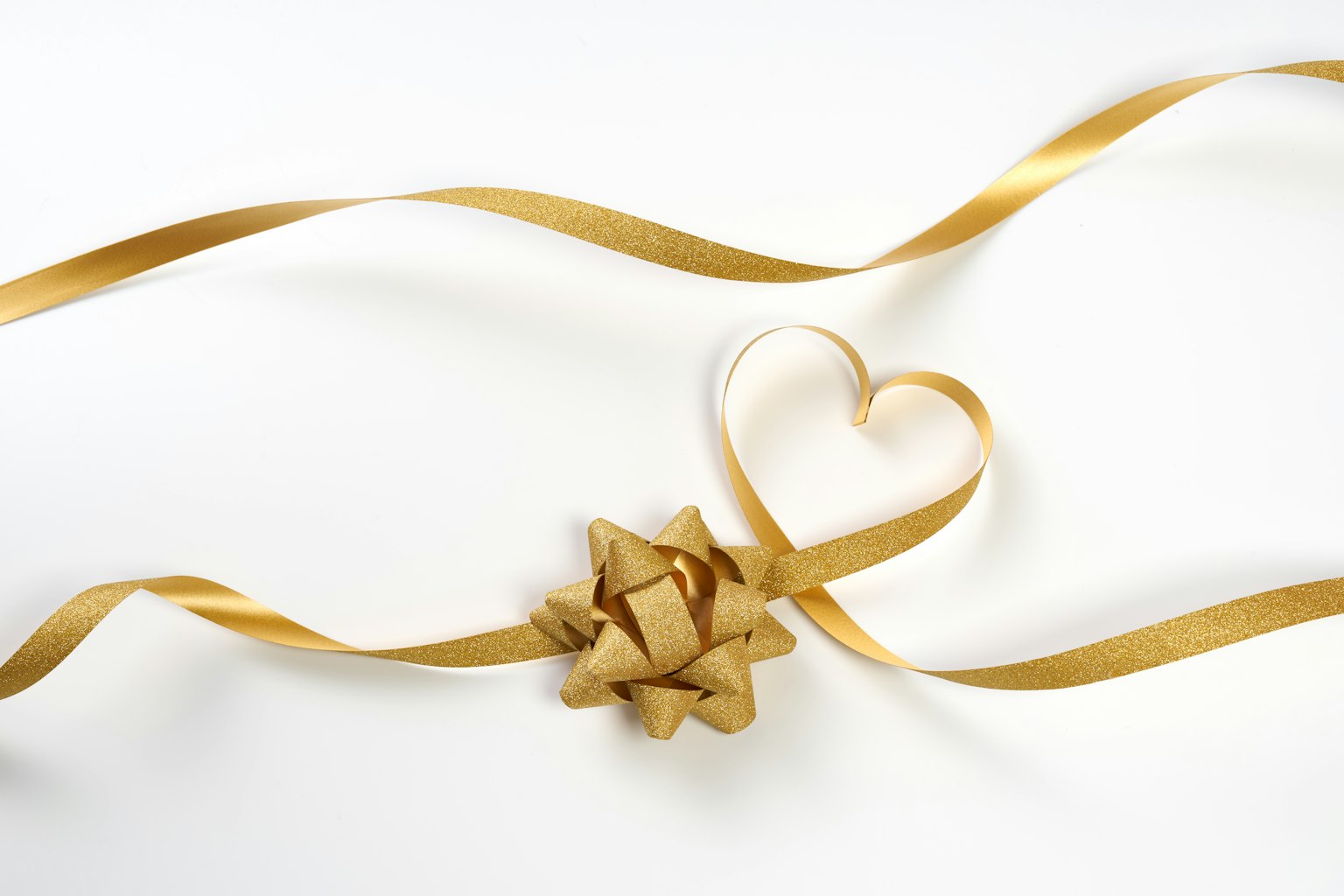 Golden ribbon and heart-shaped ribbon with a decorative bow