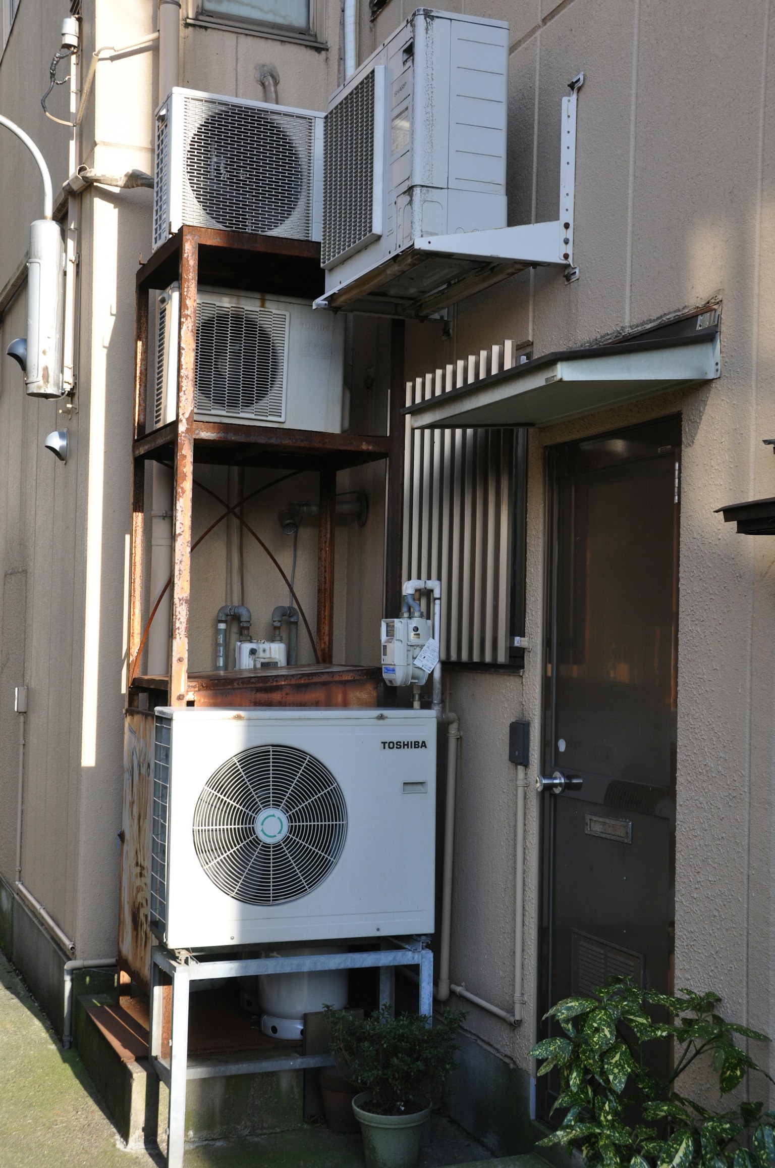 Vue extérieure de plusieurs unités de climatisation montées sur une structure en bois