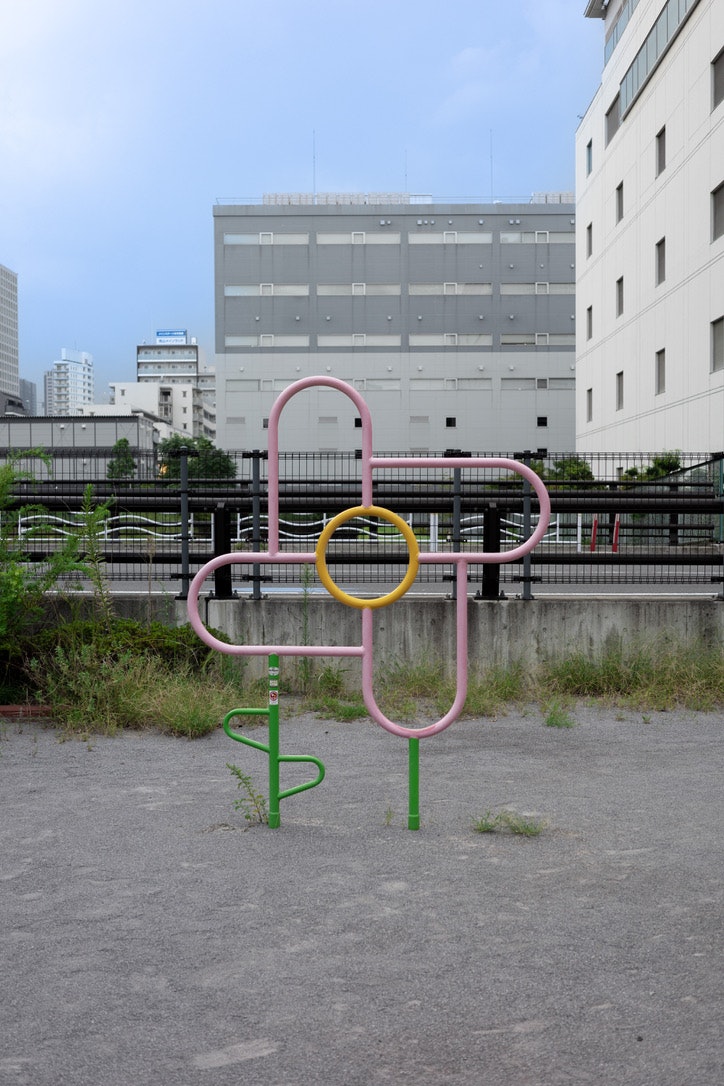 colorful metal playground equipment on an urban street