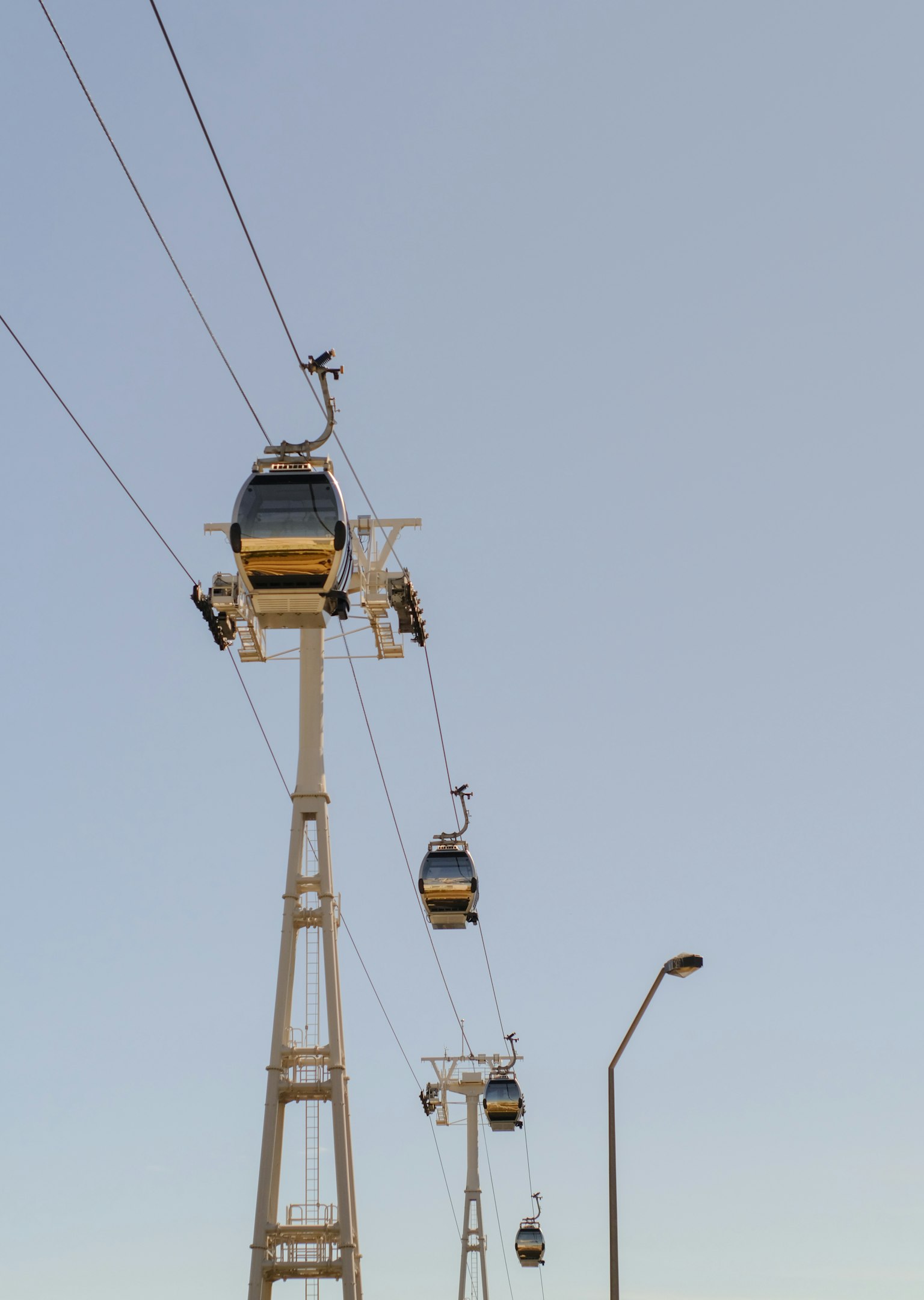 Góndolas de teleférico suspendidas en el cielo con torres de soporte
