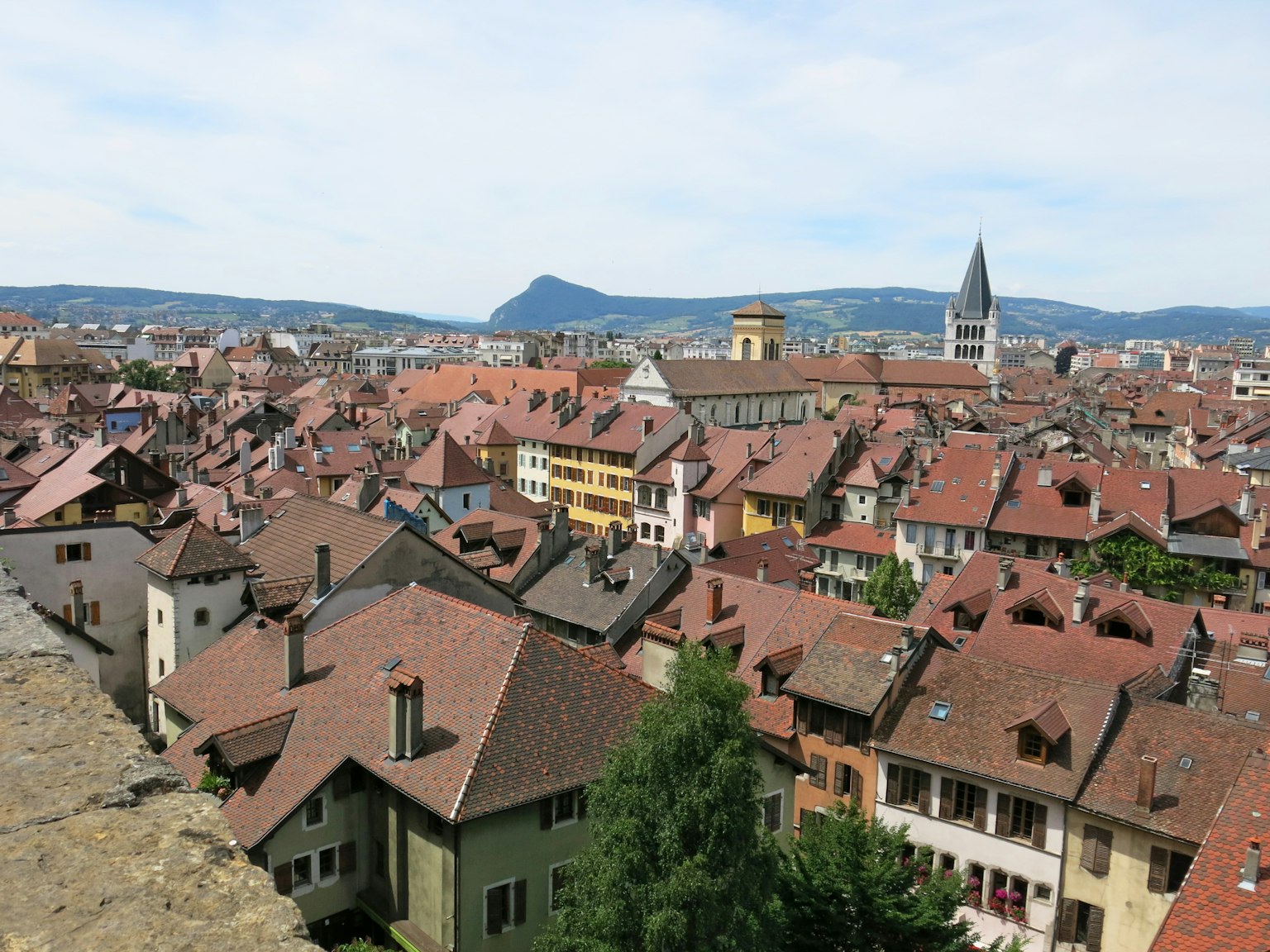 Panoramic view of Freiburg with red-roofed houses and distant mountains