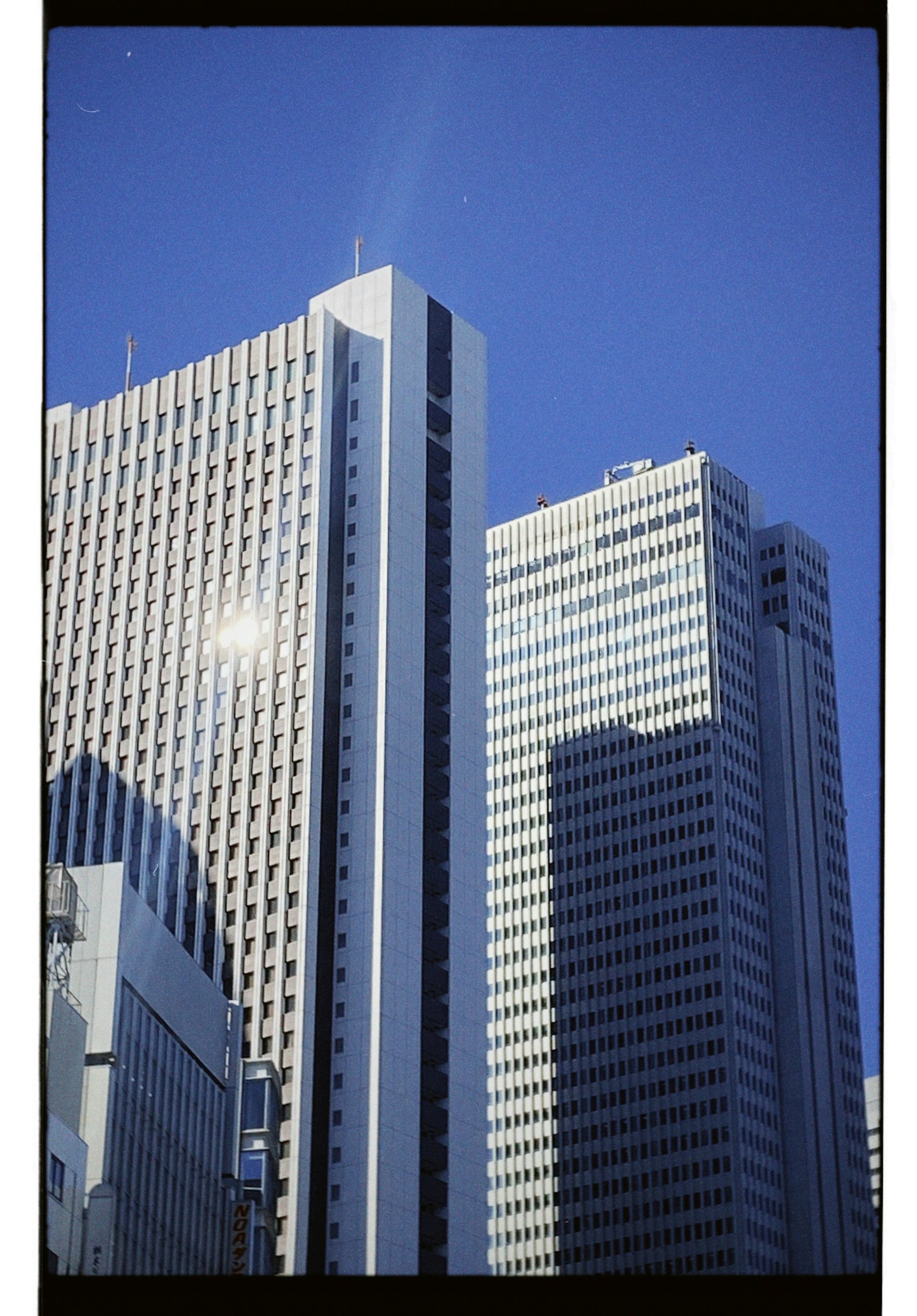 Close-up of skyscrapers under a clear blue sky