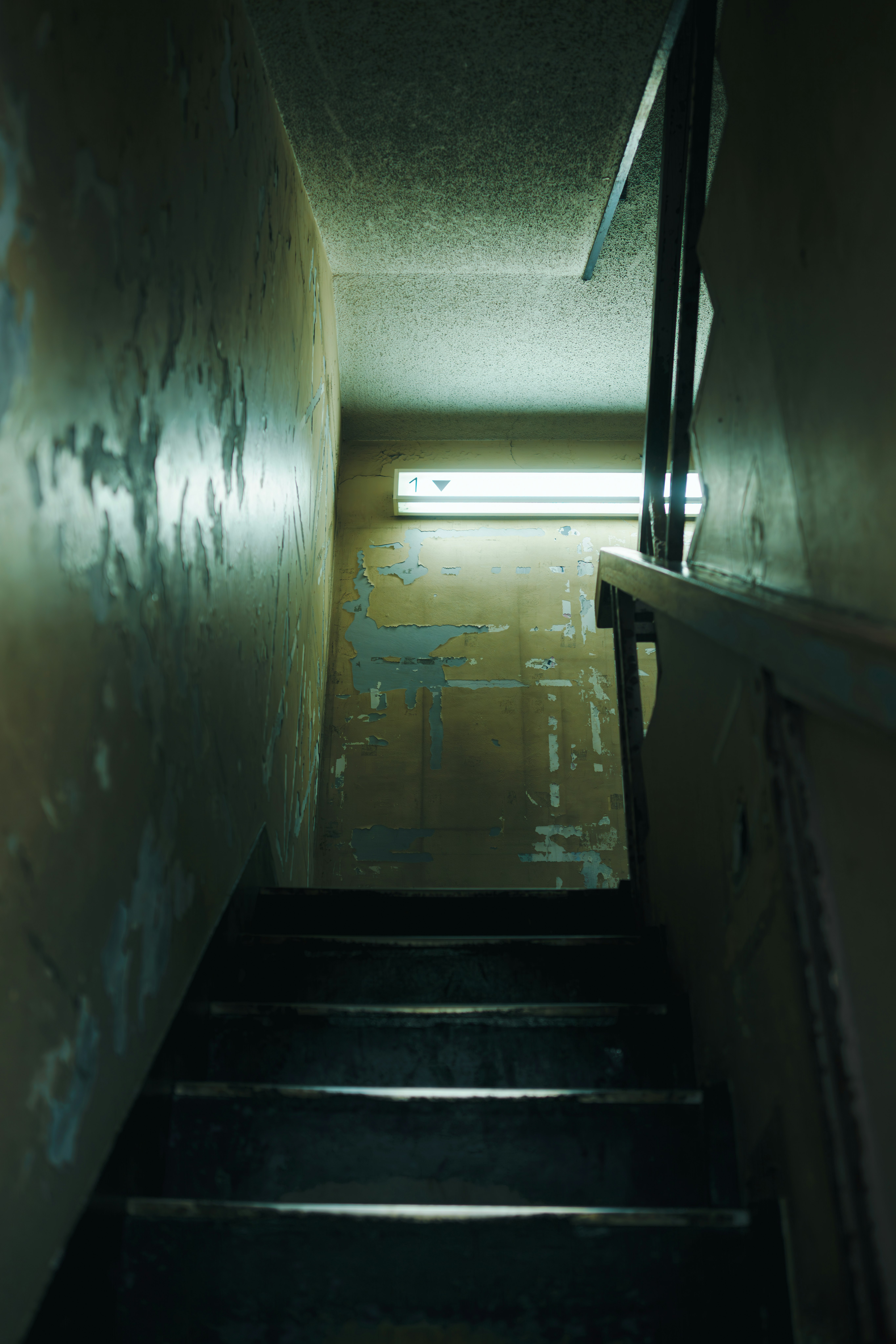 Dim stairwell landing and corridor walls
