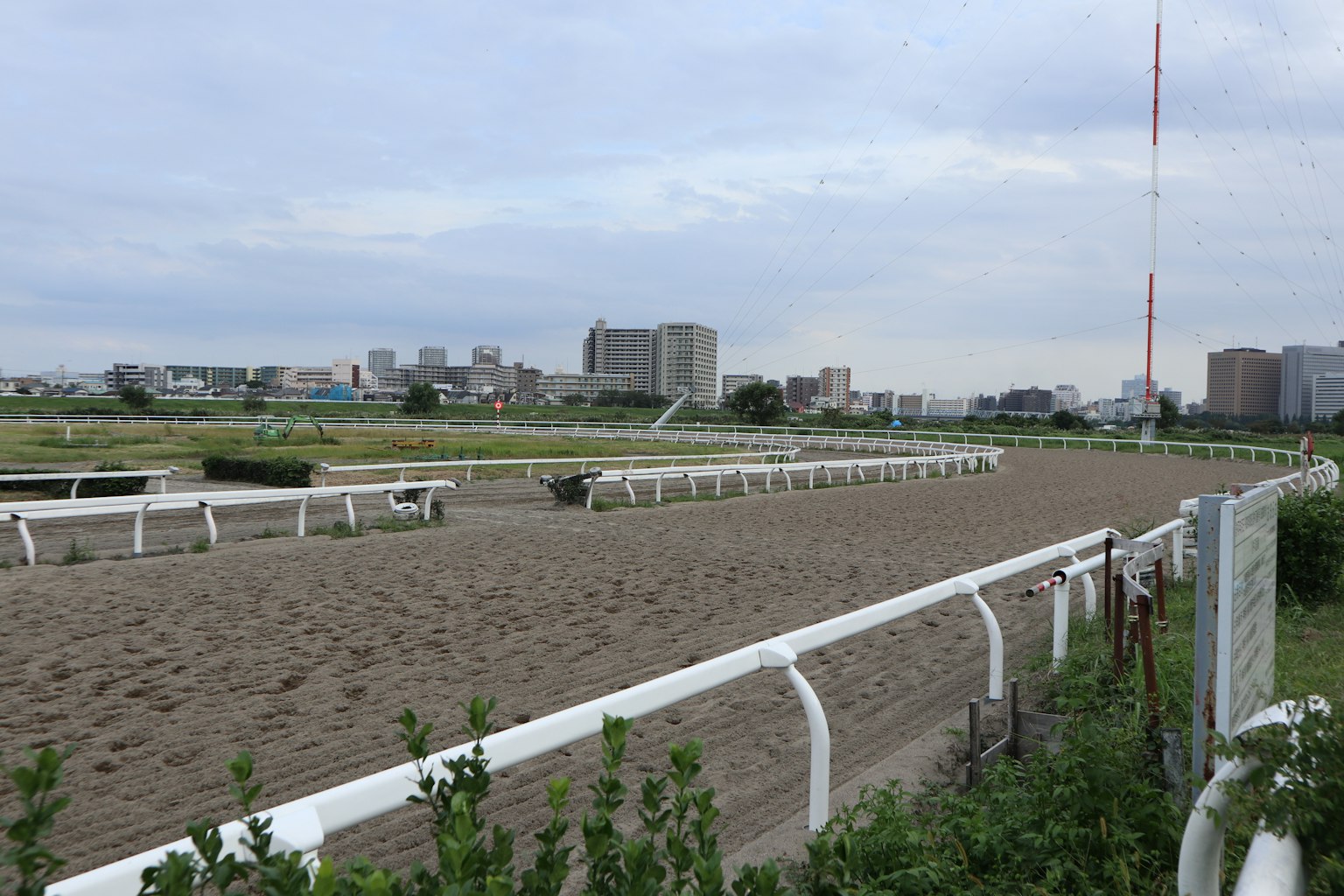 View of a horse racing track with surrounding buildings