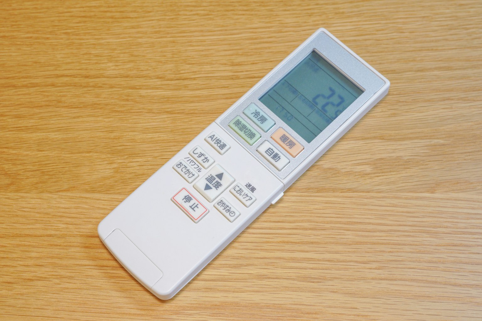 White remote control placed on a wooden table