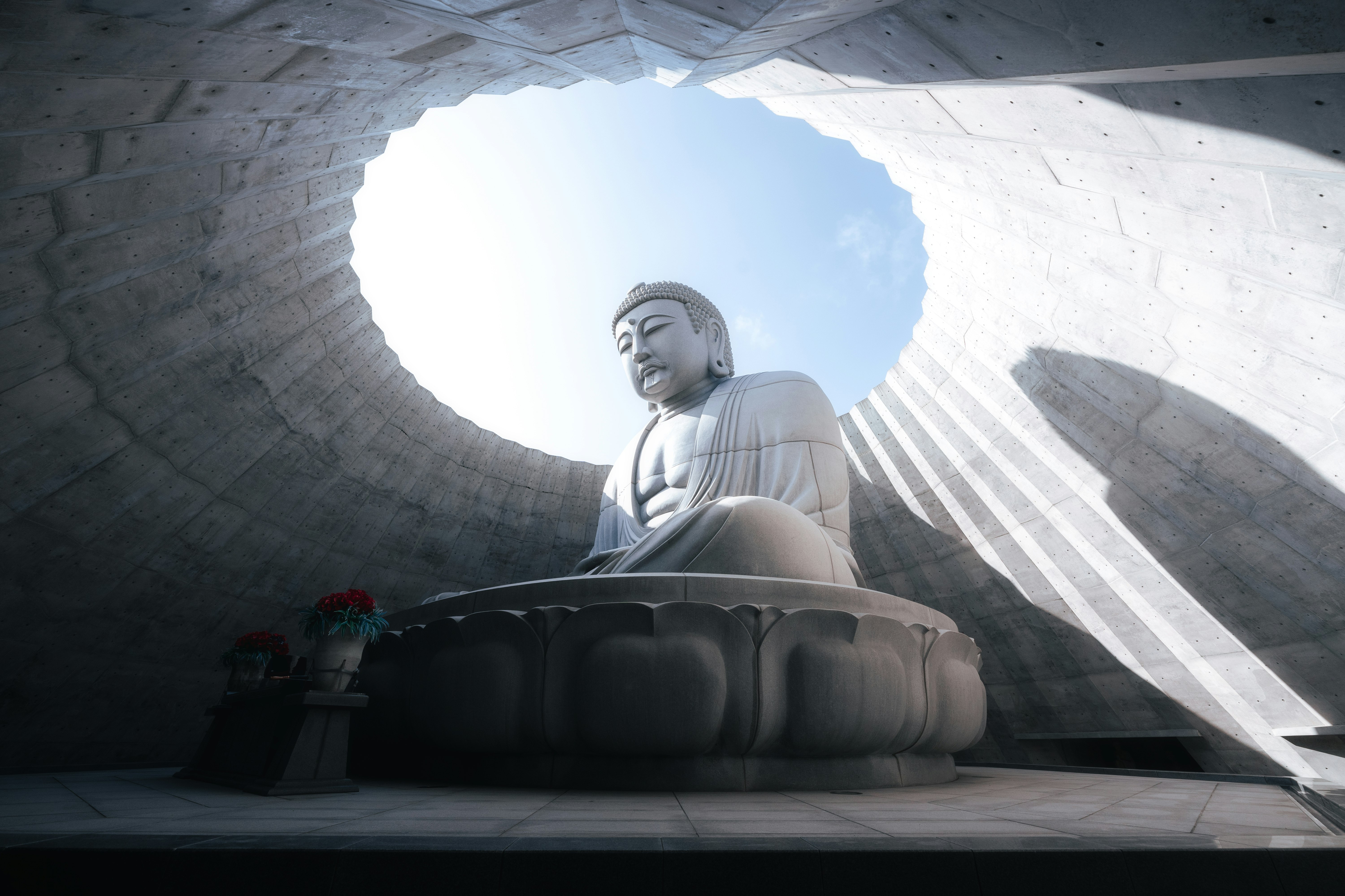 Buddha statue meditating inside a circular stone chamber