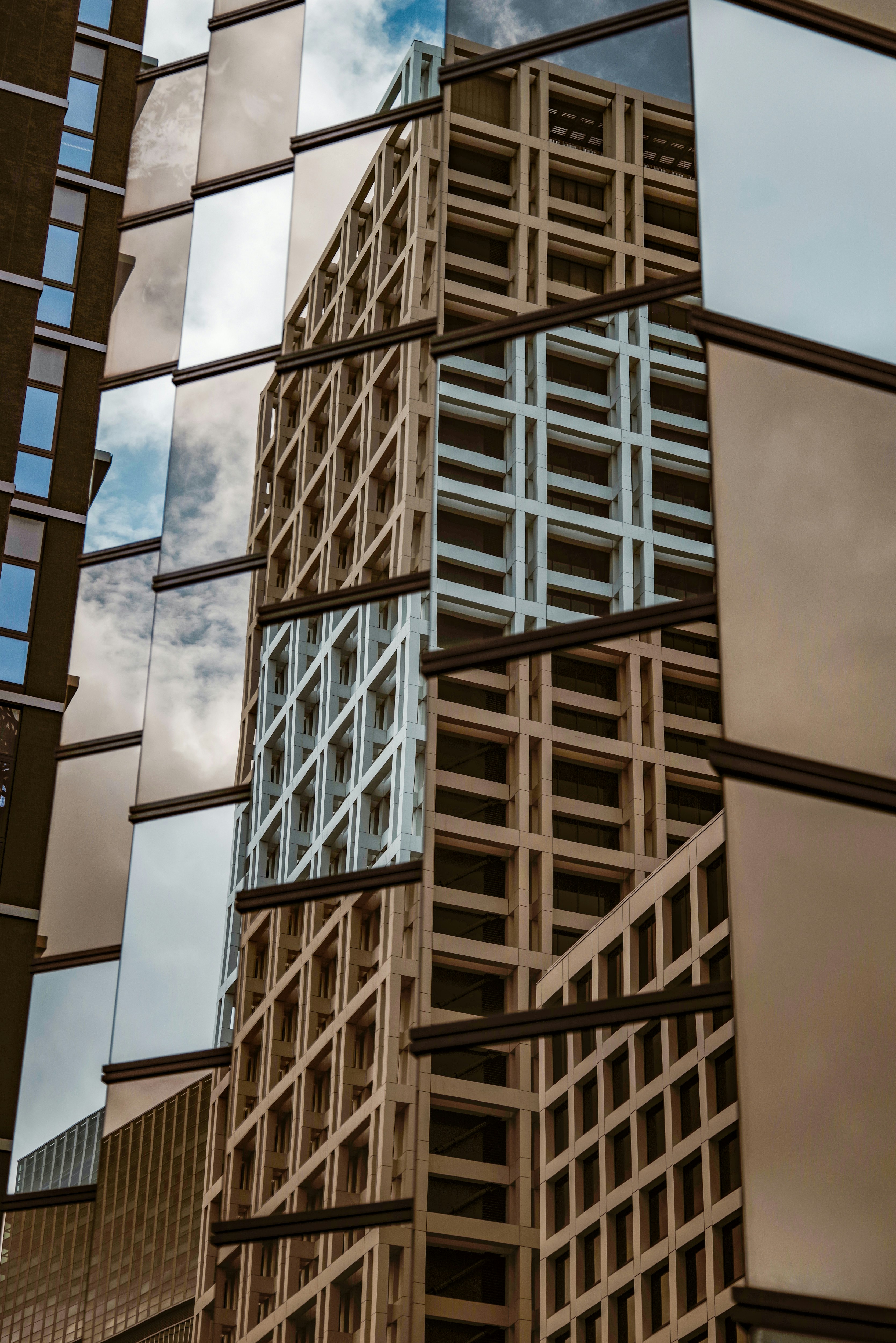 grid-like structure along a building facade with a slice of sky