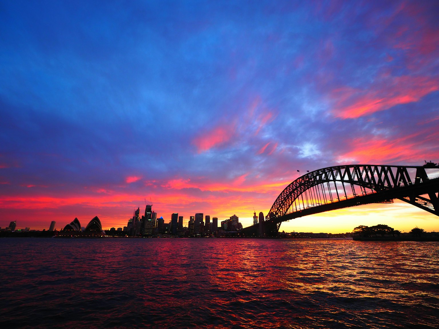 Cầu Cảng Sydney silhouetted trước hoàng hôn rực rỡ