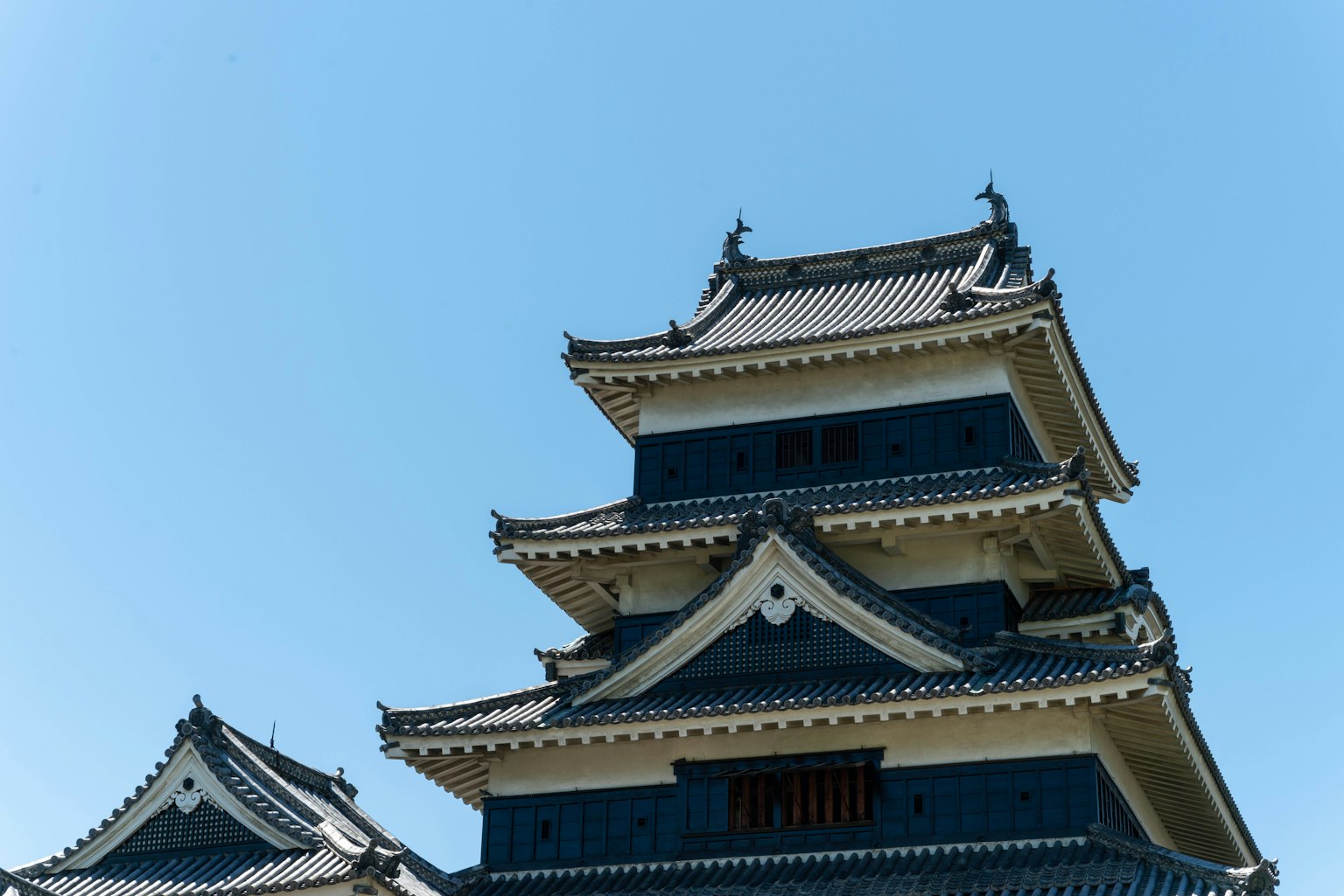 Beautiful tower of Matsumoto Castle under a clear blue sky
