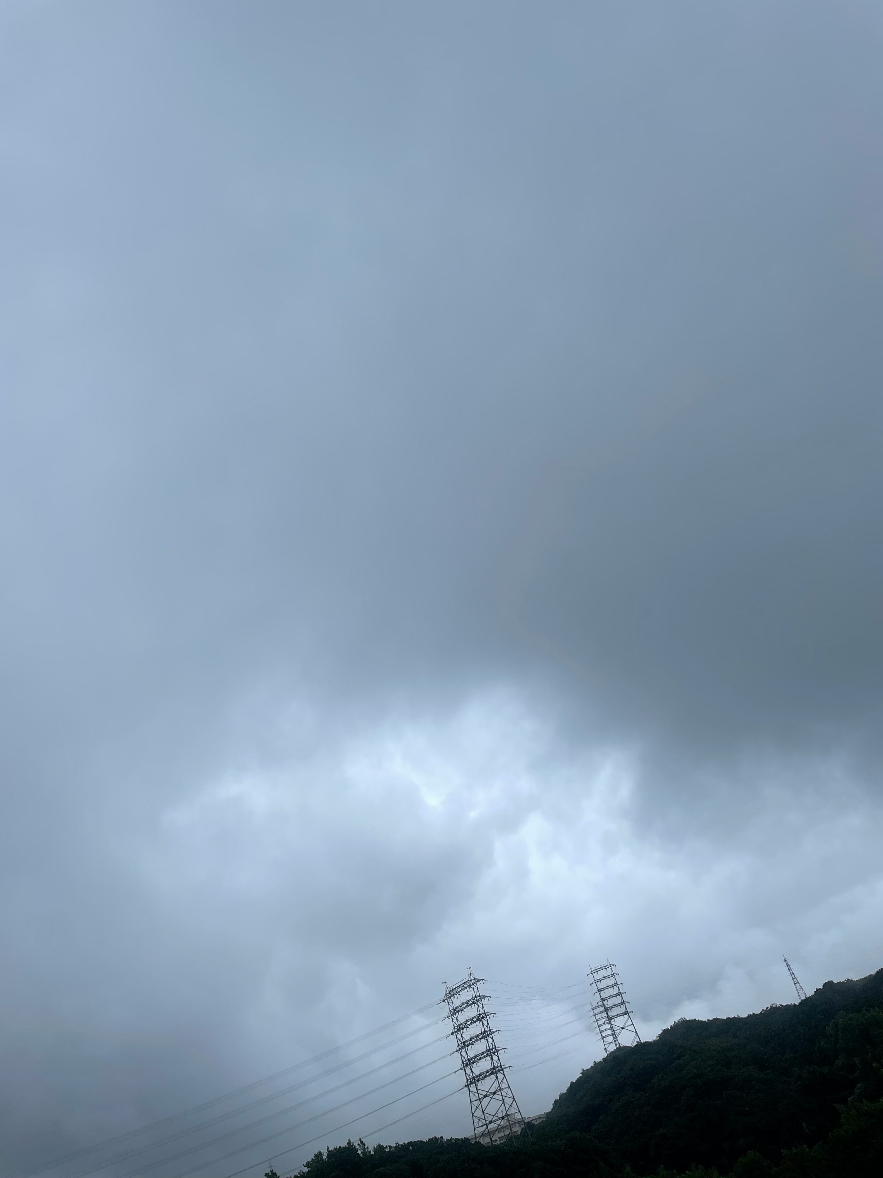 Overcast rainy-season sky over a mountain ridge