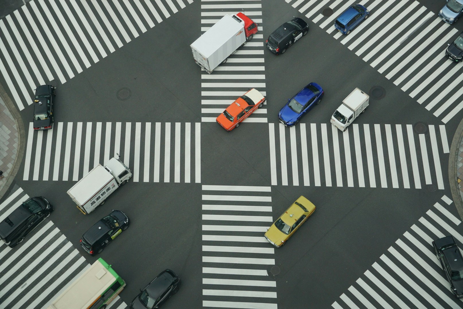 street intersection with cars and crosswalk markings