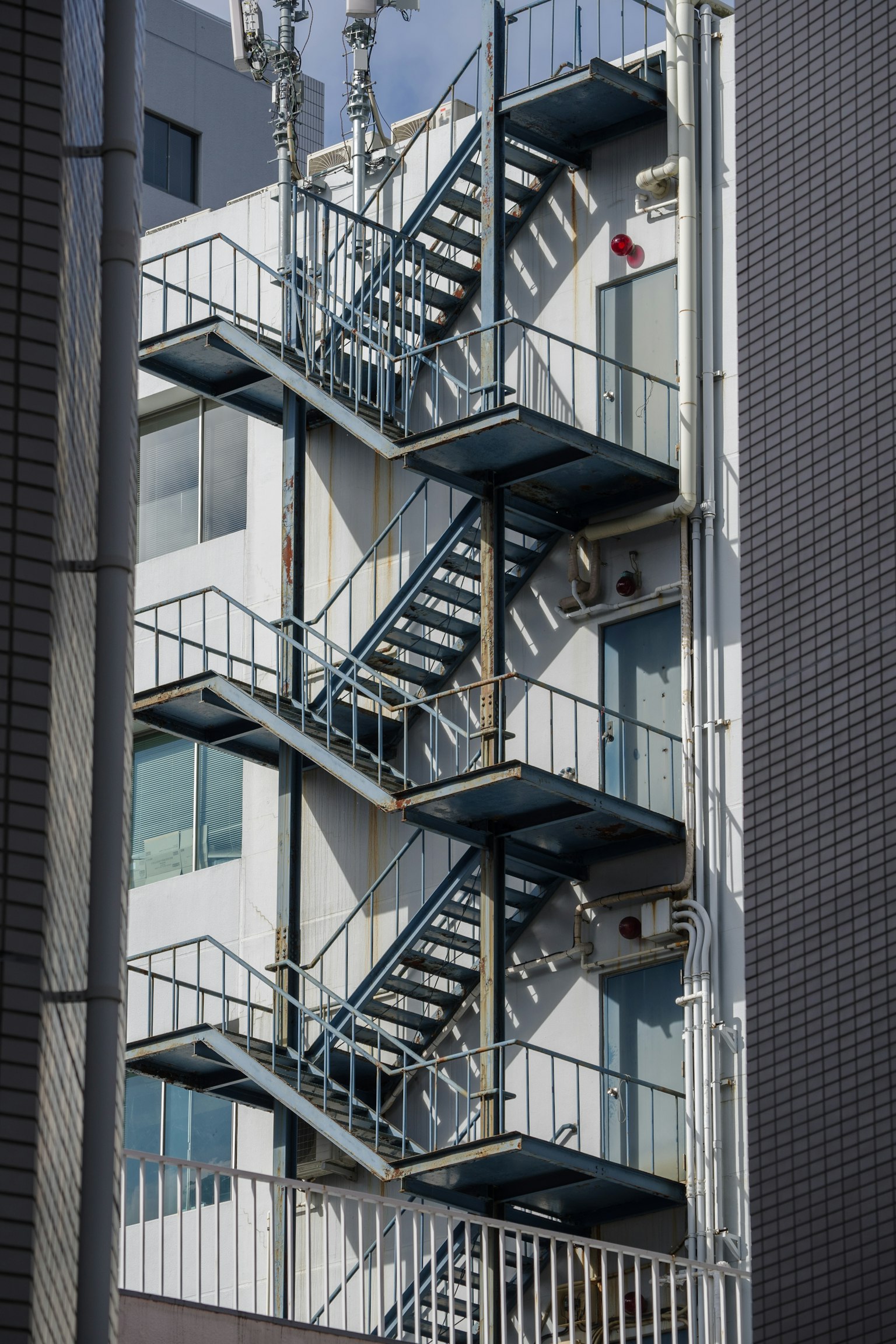 Metal fire escape stairs attached to a building exterior