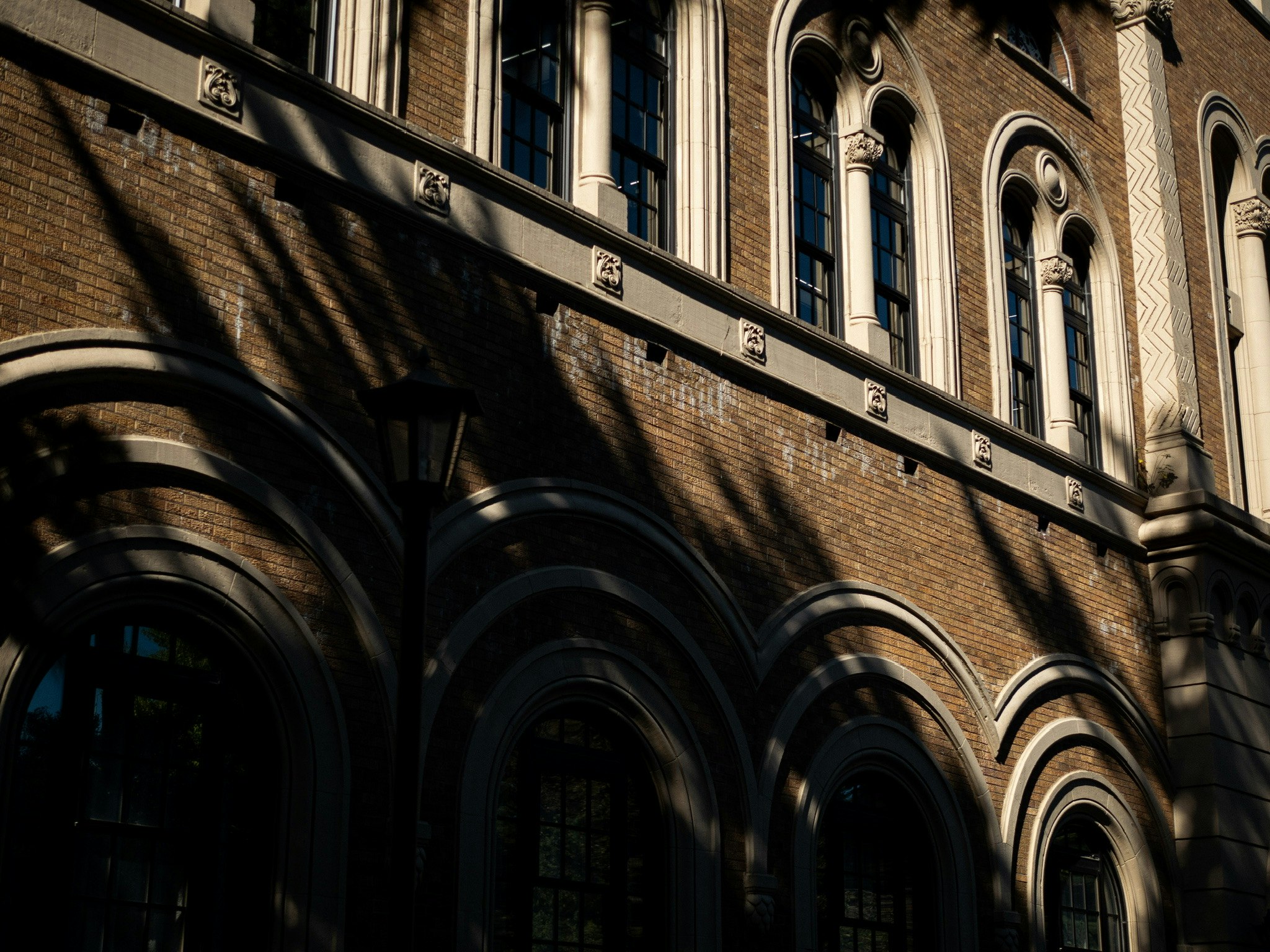 Exterior of historic brick building with arched windows and columns