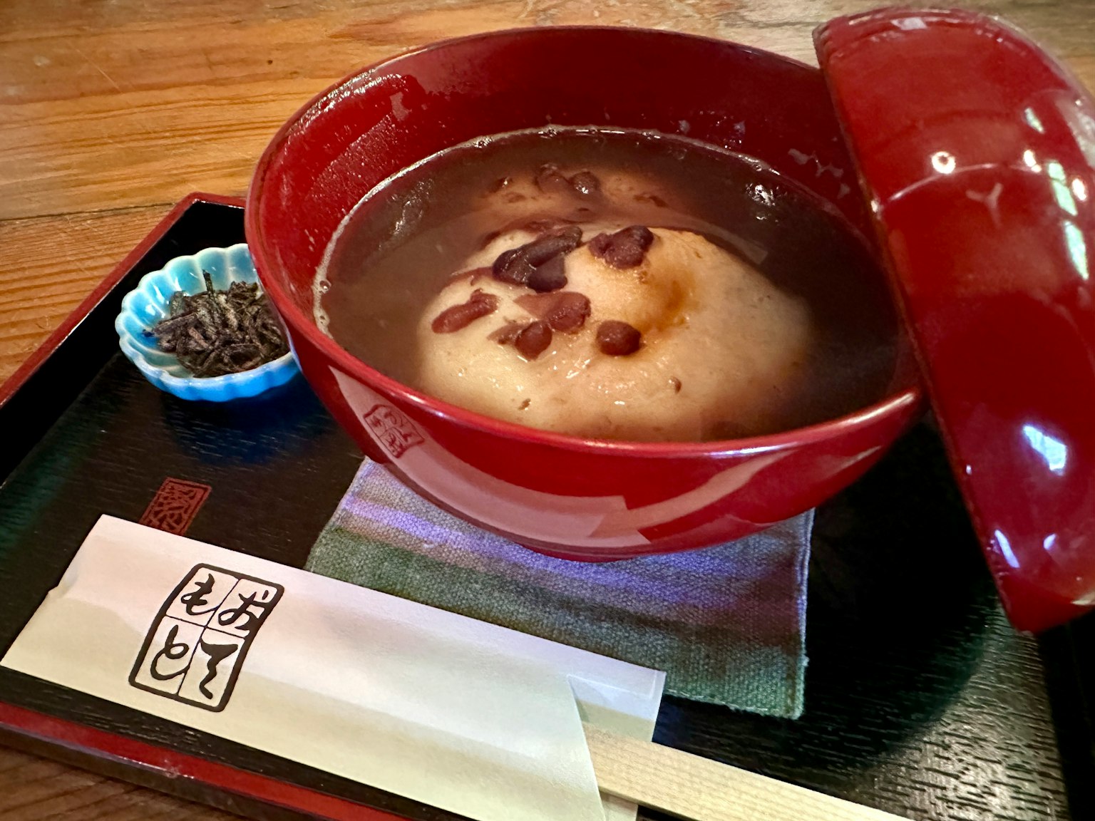 Sweet red bean soup with mochi in a red bowl