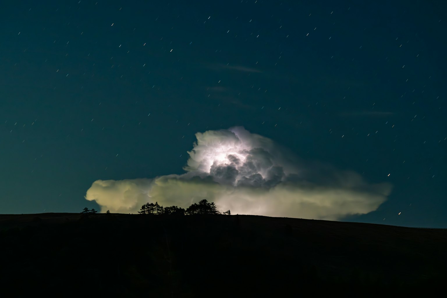 Night sky featuring a thundercloud and stars