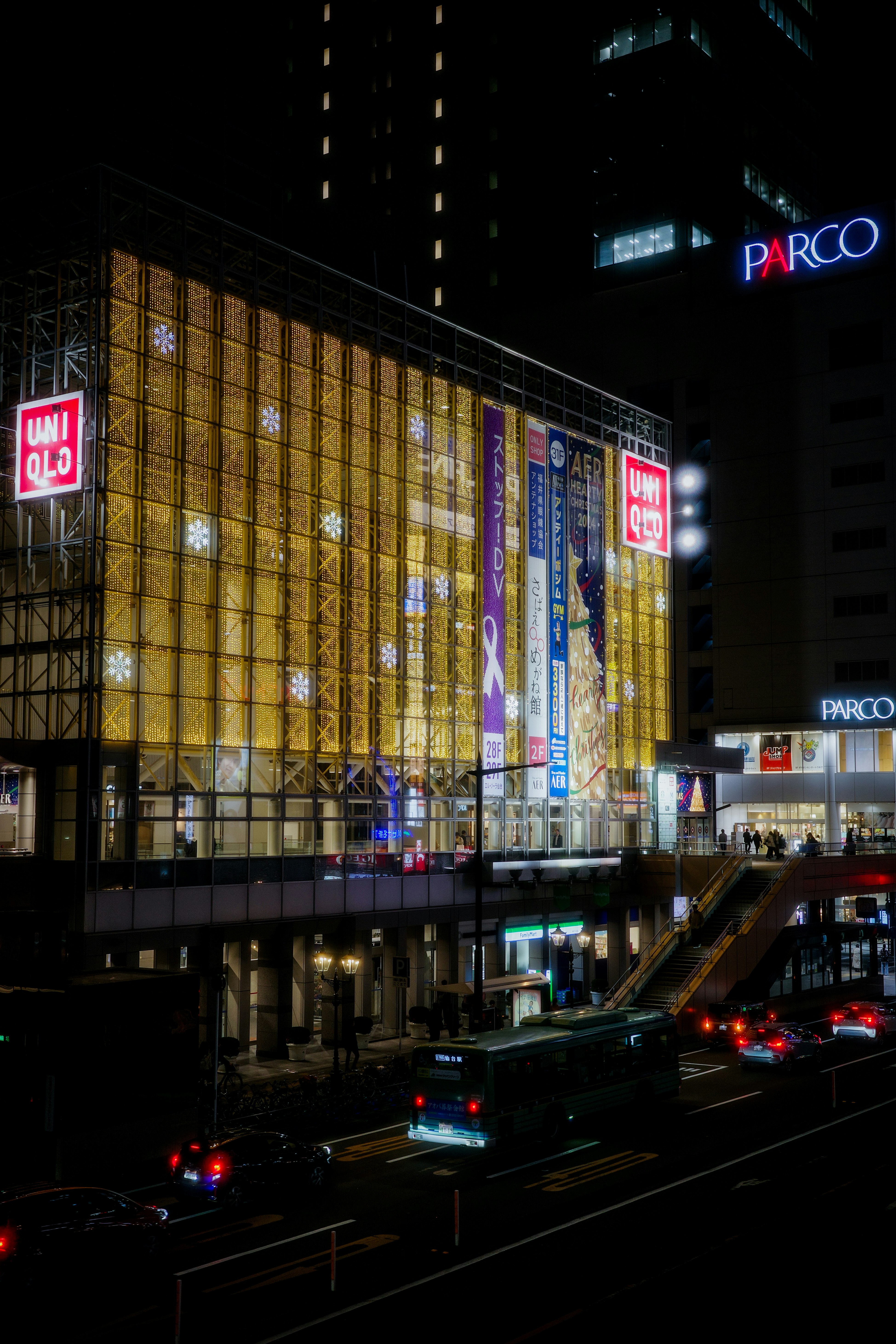 夜の大通りとビル群、ネオン看板が光る街並み