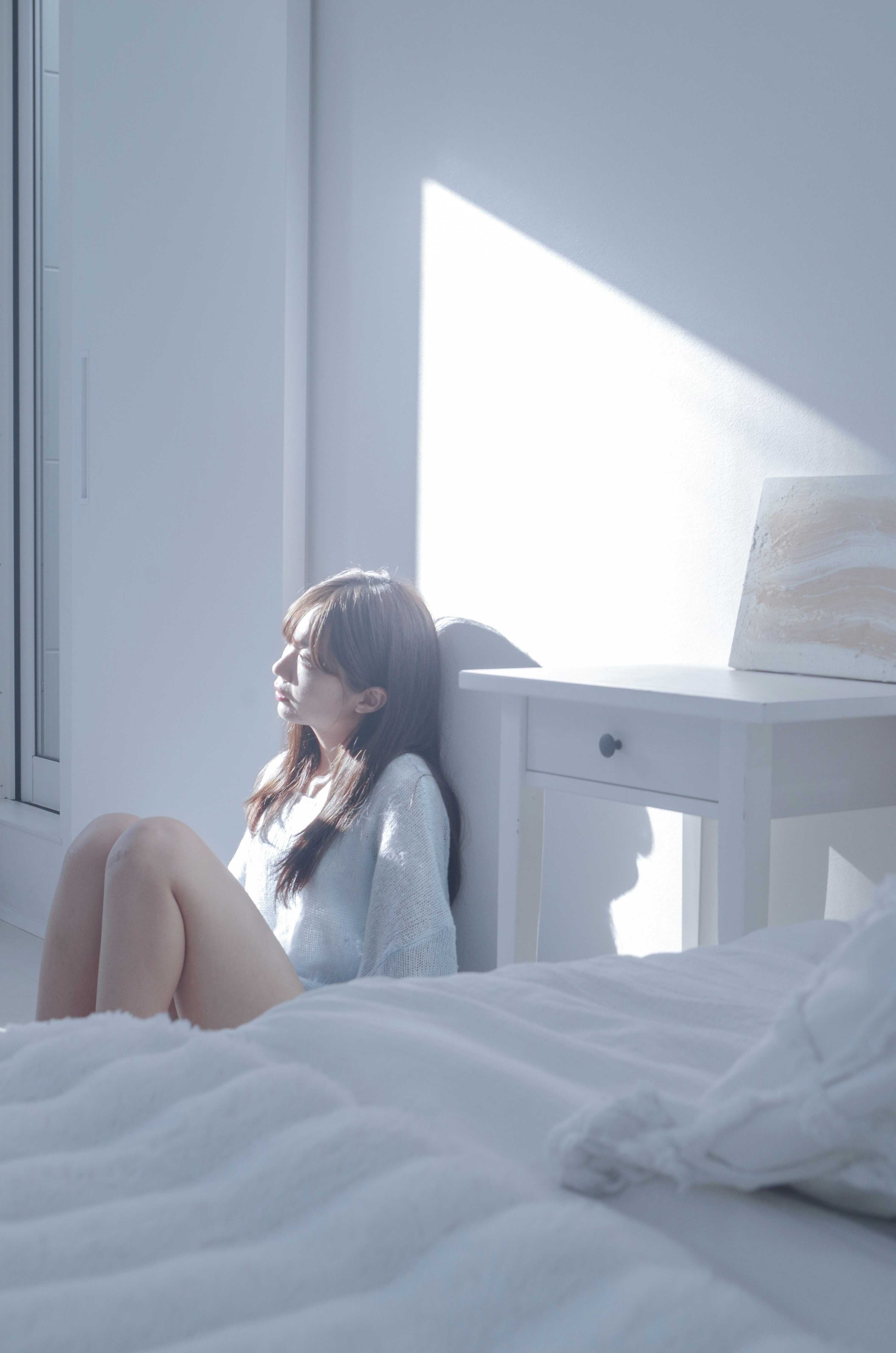 side profile of a woman lying on a bed