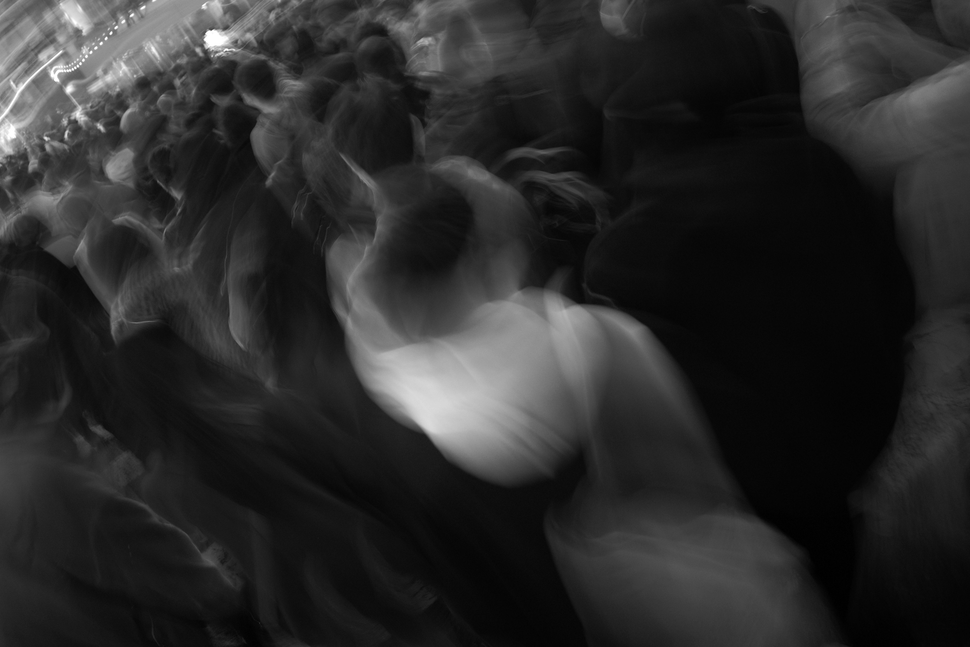 monochrome silhouette of people embracing in a dark indoor setting