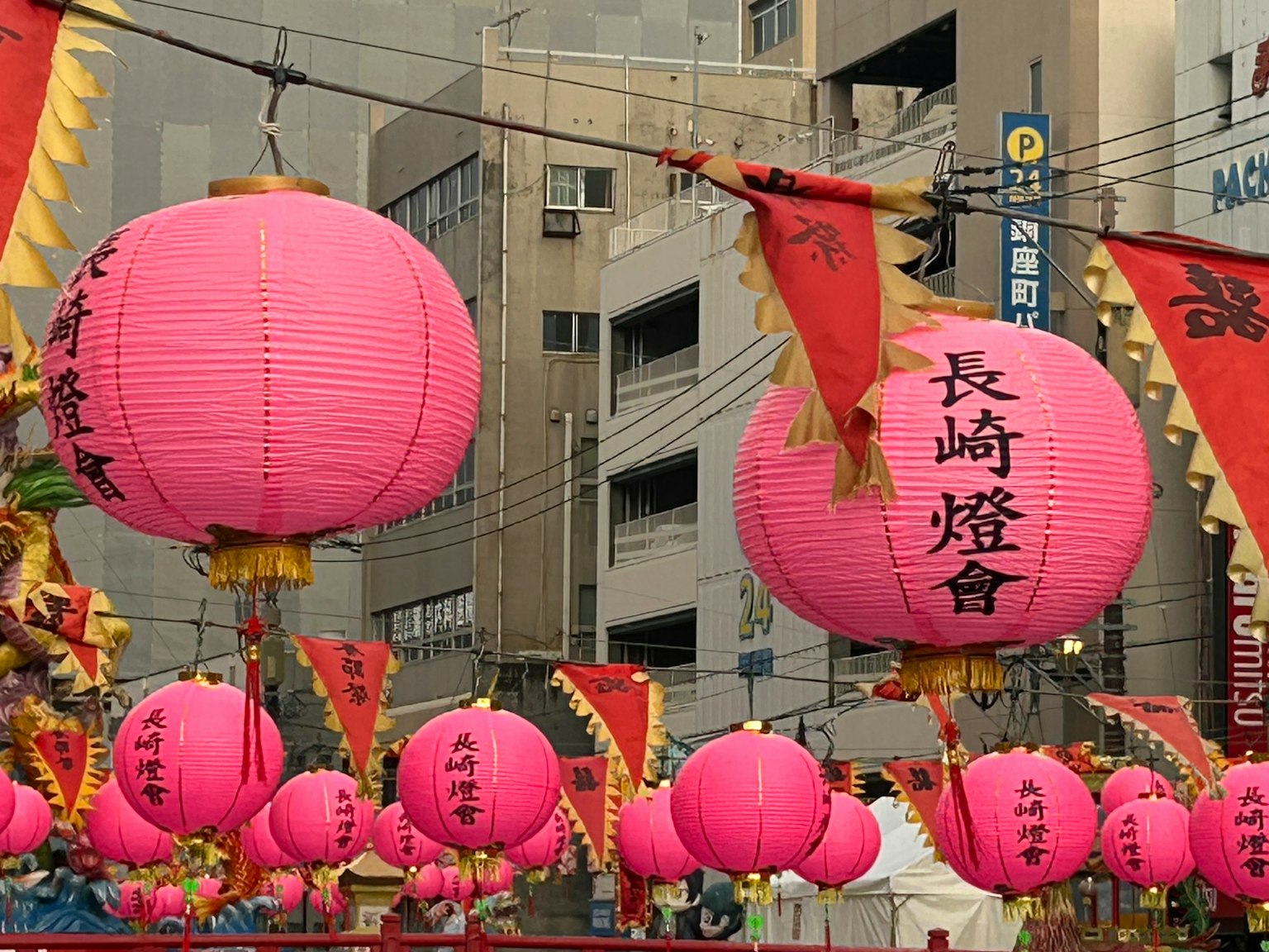 Colorful street scene adorned with pink lanterns