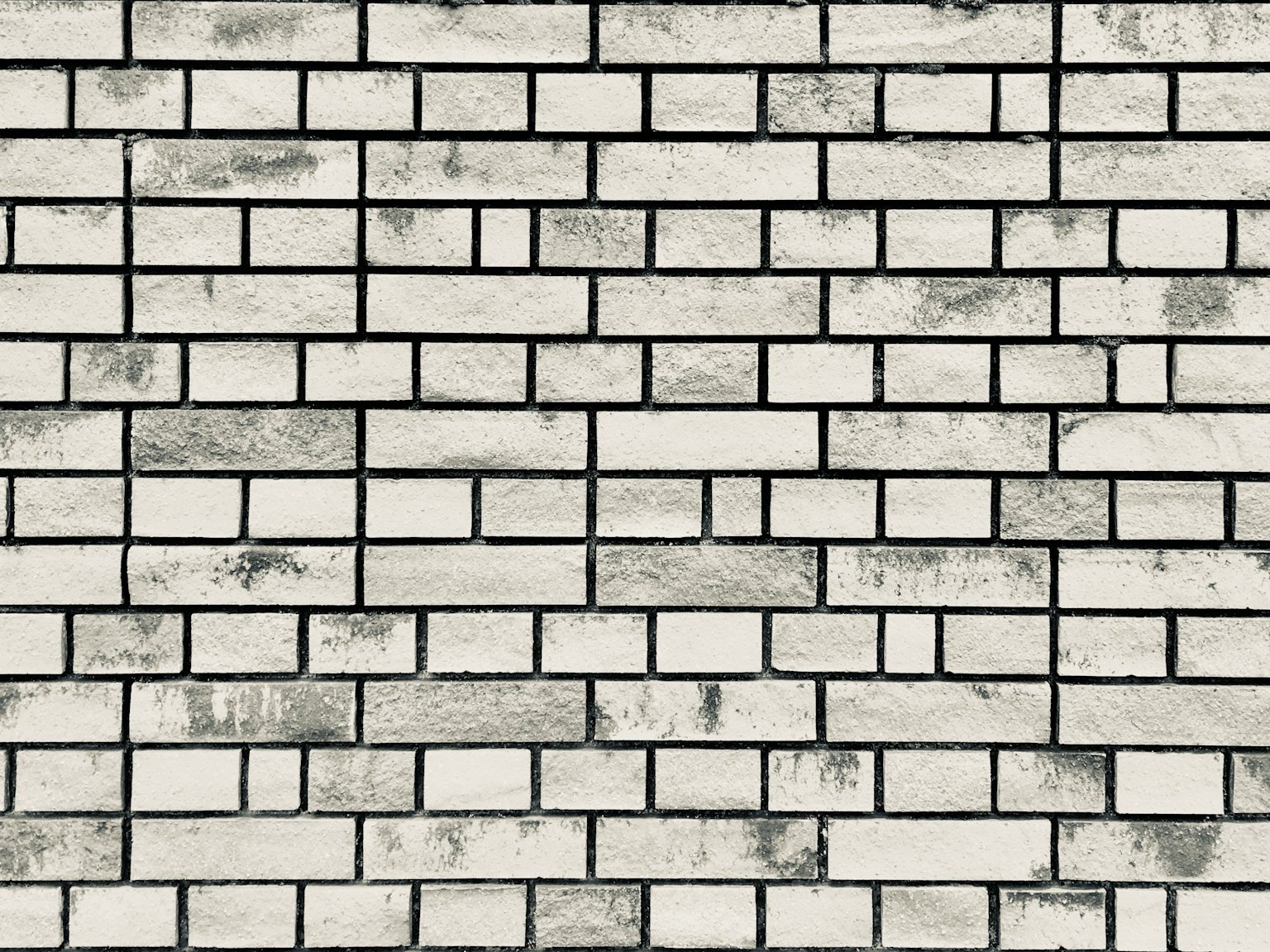 Muratura in mattoni bianchi con linee di malta visibili